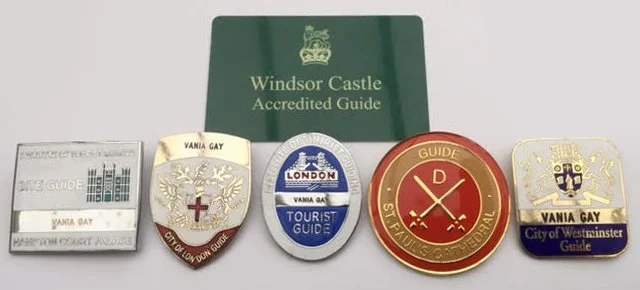 Collection of five travel pins and a green folded guidebook for Windsor Castle.
