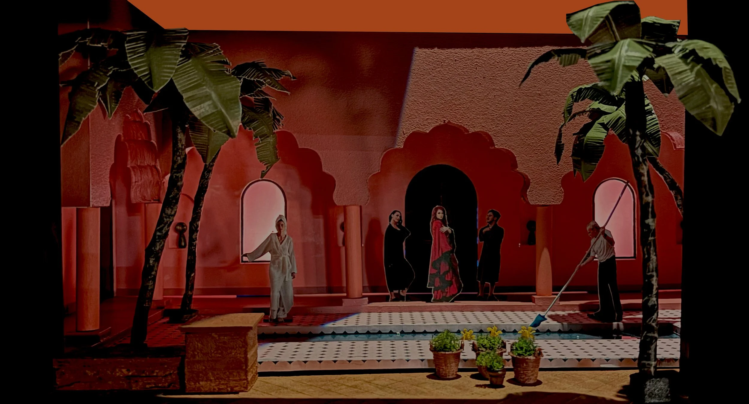 A stage set with orange walls and palm trees, featuring actors dressed in various costumes, with some holding props, in a theatrical scene.