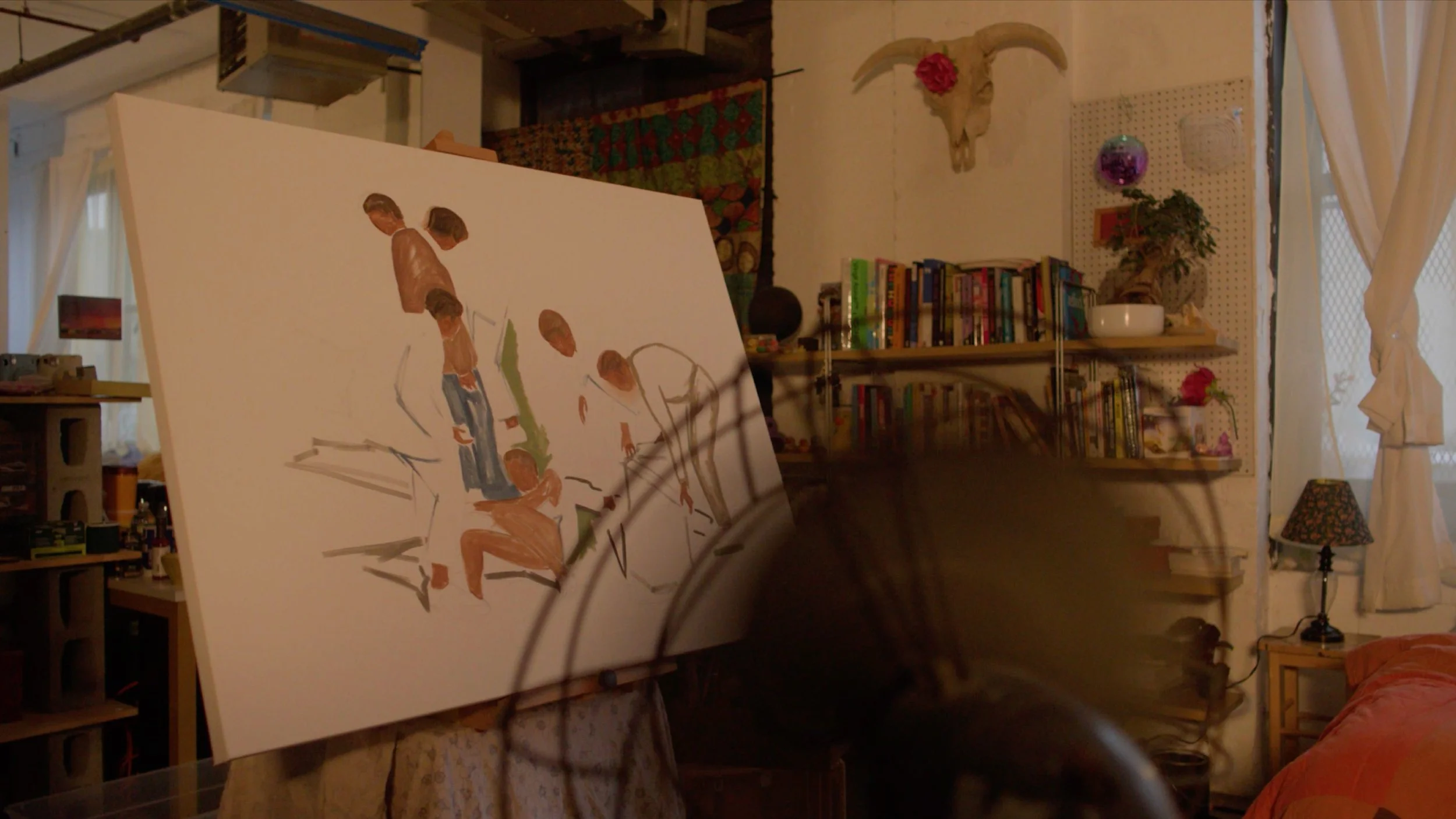 An art studio with a painting of two children on an easel, bookshelves, lamps, plants, and wall decorations in the background.