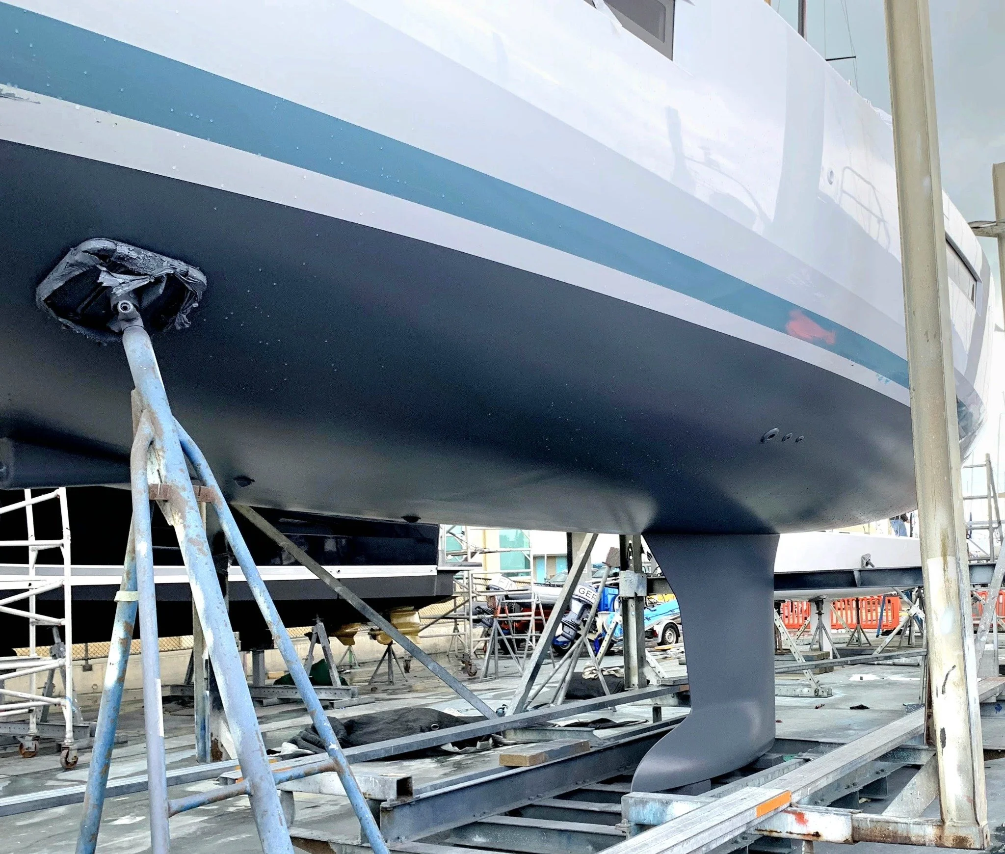 Antifouled yacht hull and keel on the hardstand.