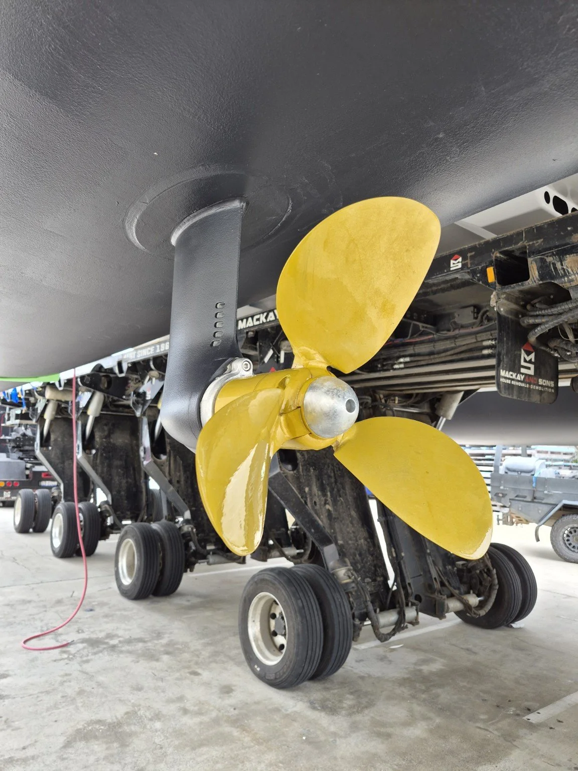 Marine propeller with gold coating beneath the boat.