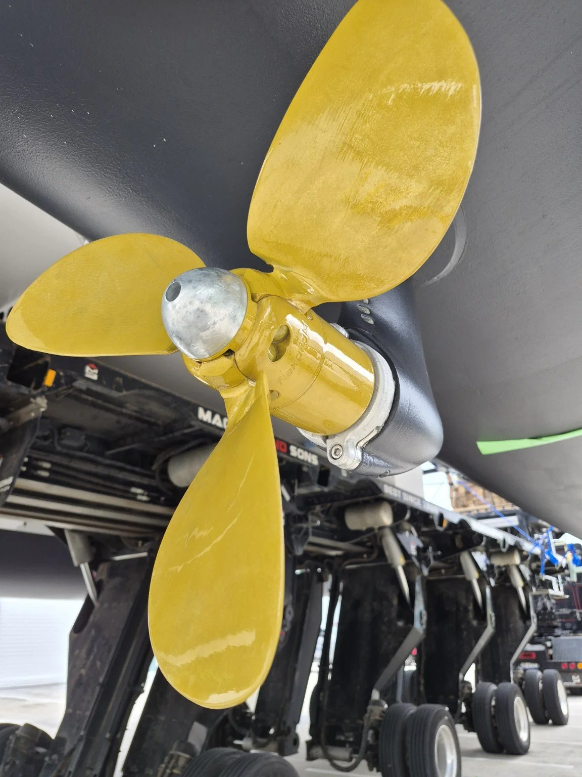 Gold-coated marine propeller beneath the hull.