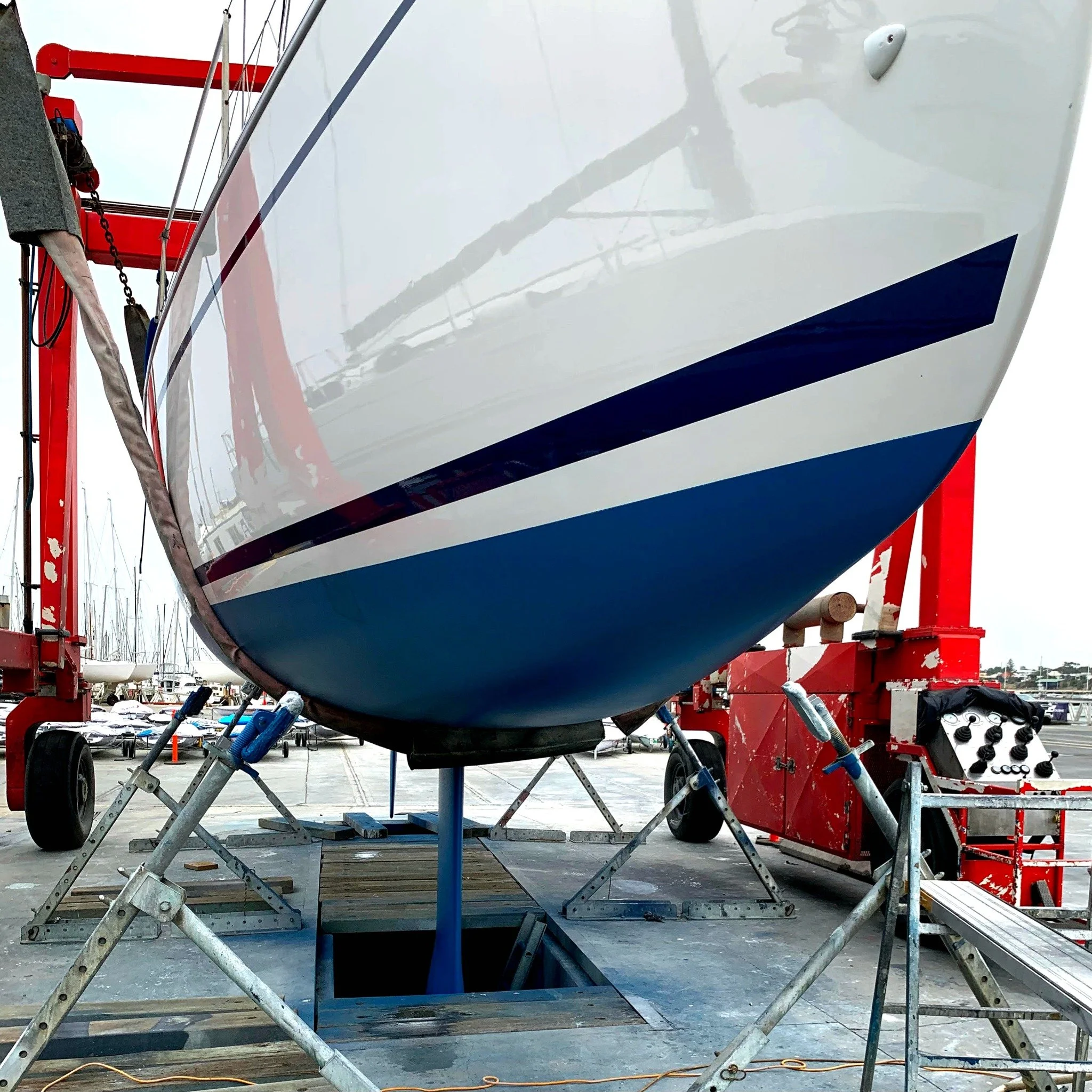 Fresh blue antifouling and polished yacht bow.