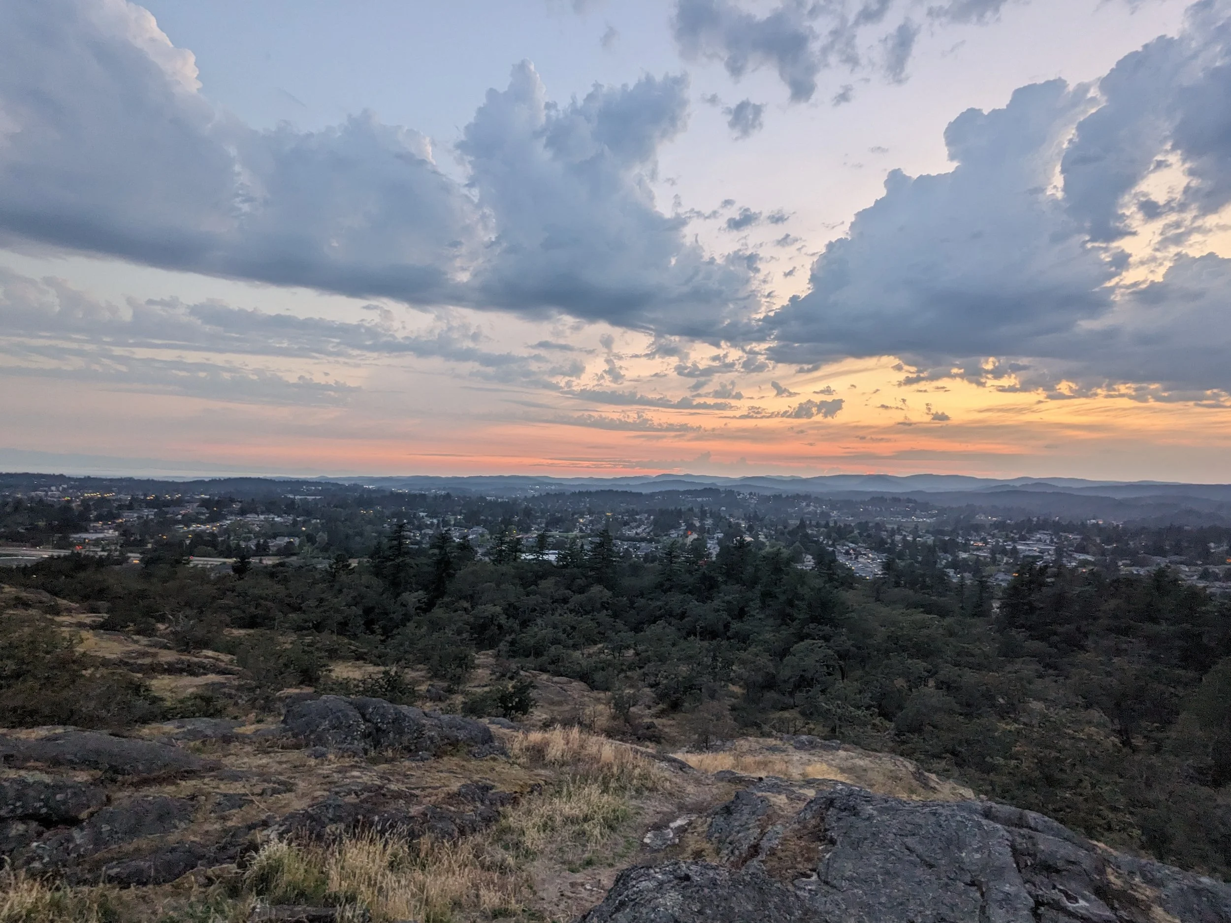 The sun is setting over the greater victoria area