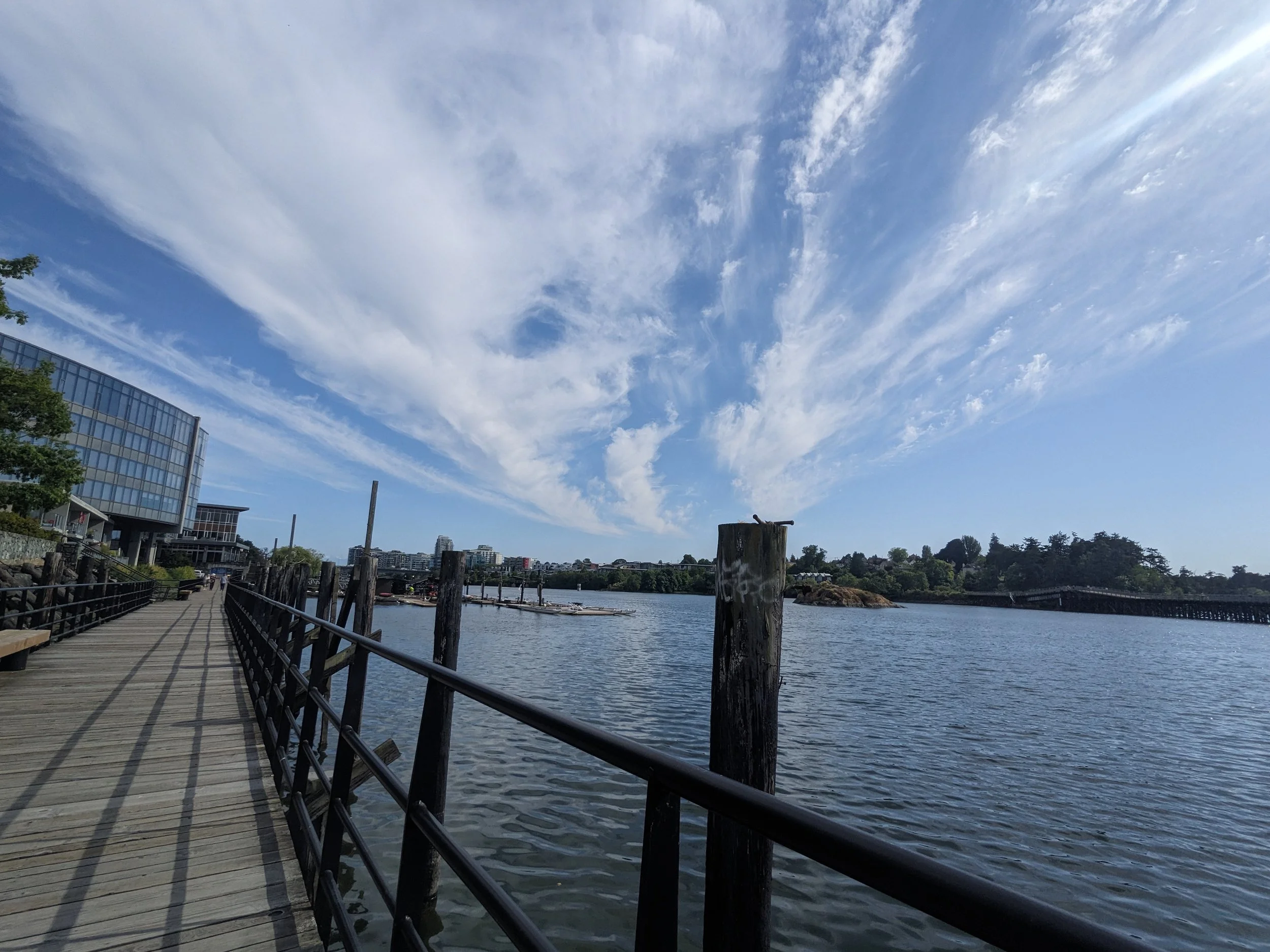 walking bridge overlooking a sunny ocean harbour