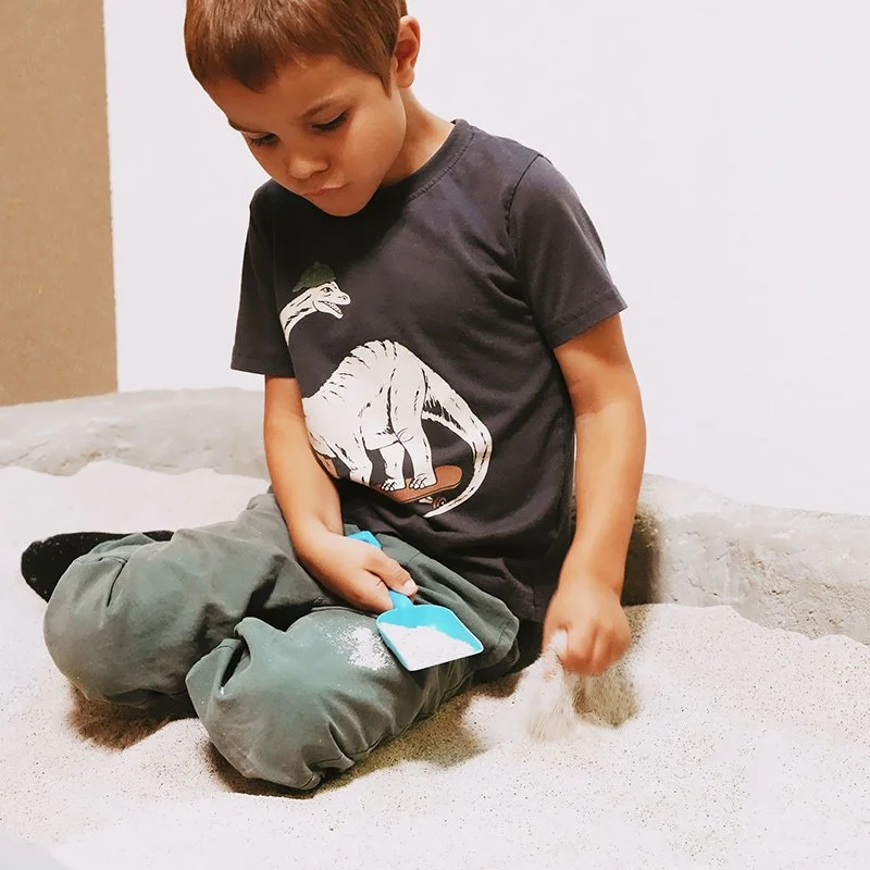 Boy playing in sand at occupational therapy office in Redding, CA