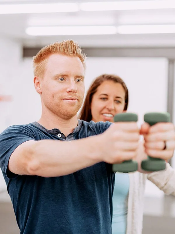 Man working with physical therapist at Sensory Innovations in Redding, CA