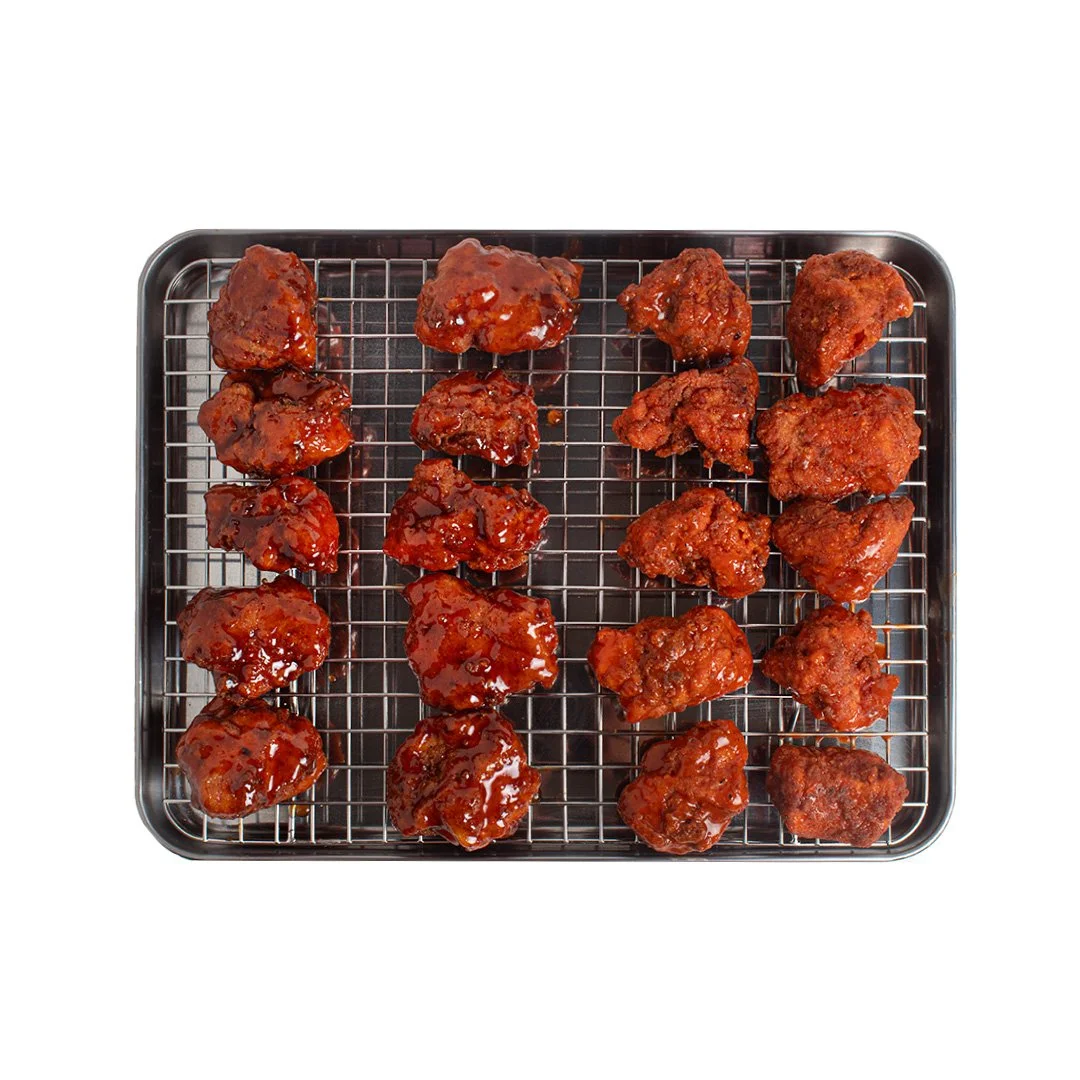 Tray of fried chicken pieces coated in glossy sauce.