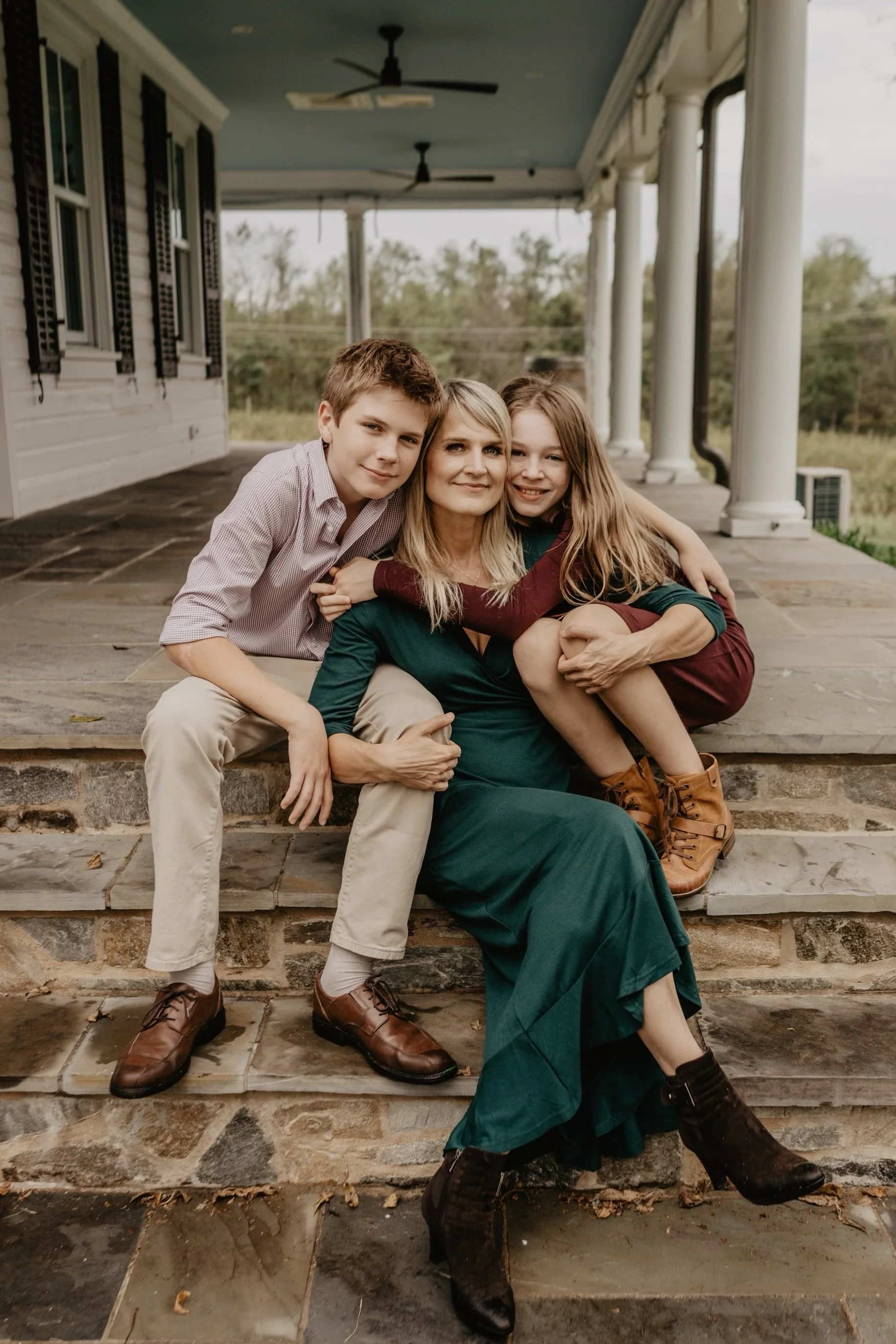 Renata Briggman and her family outdoors on the step