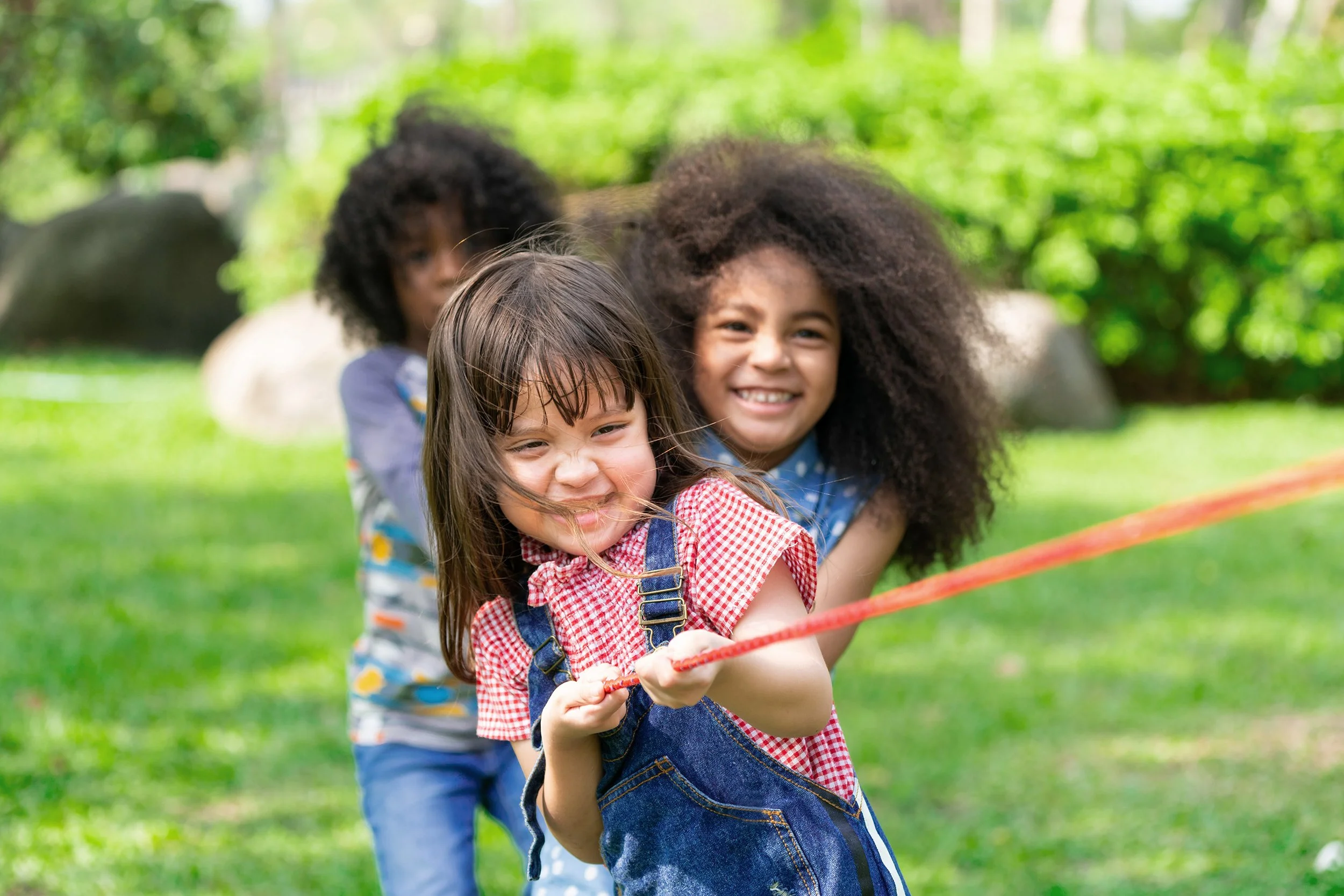 children playing tug a rope in a day camp in Maryland