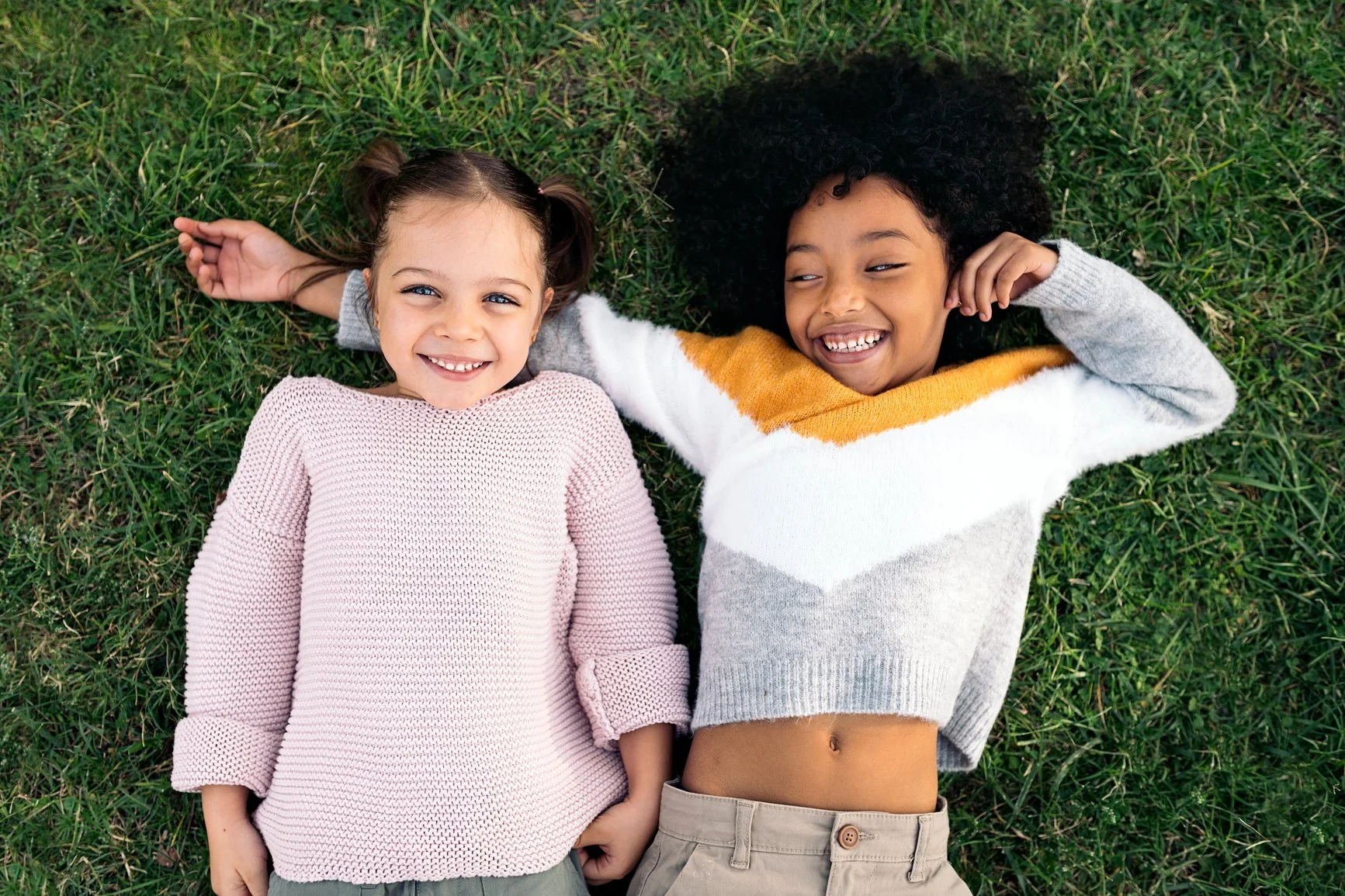 two children laying in the grass after counselling for children in Friendship Heights, DC
