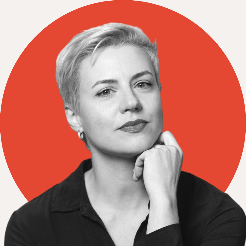Profile picture of company owner, woman with short hair on red background.