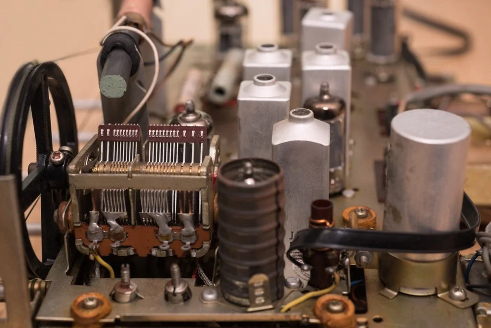 Close-up of vintage electronic or radio equipment with vacuum tubes, resistors, and circuitry.