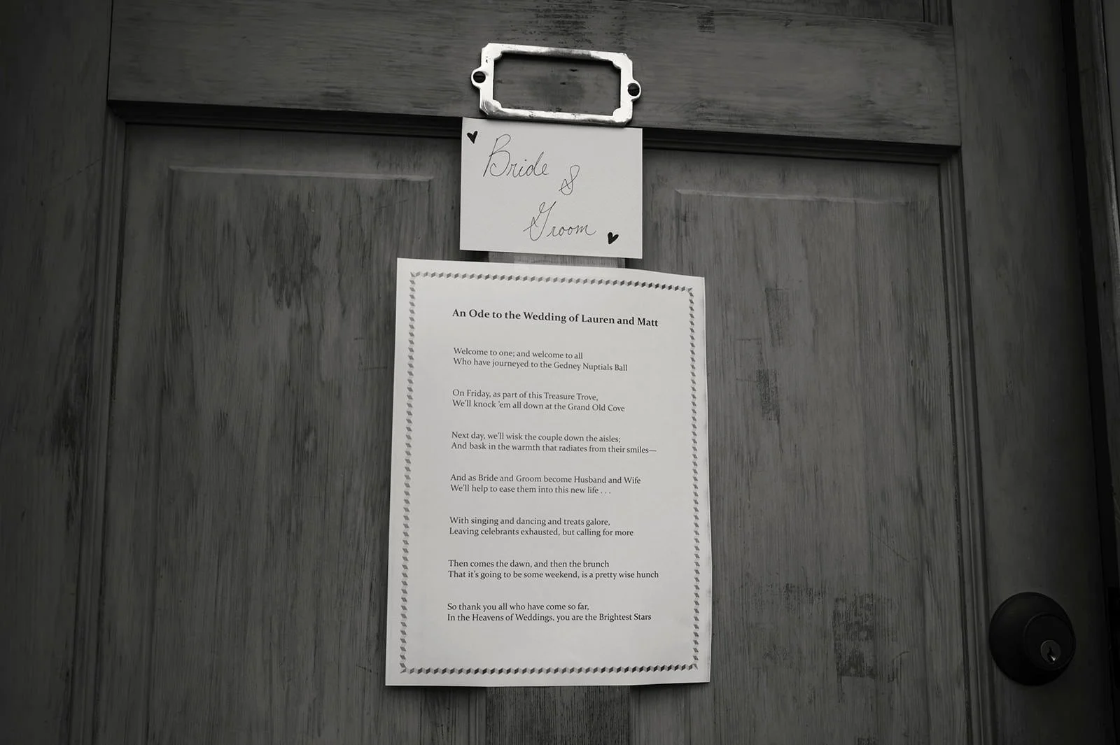 A door with a sign that reads 'Bride & Groom' and a poem about Lauren and Matt's wedding, attached to the door