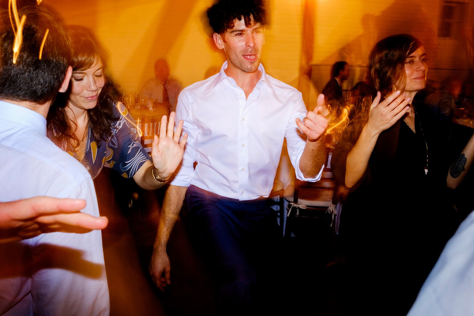 People dancing and socializing at a lively indoor party or celebration.