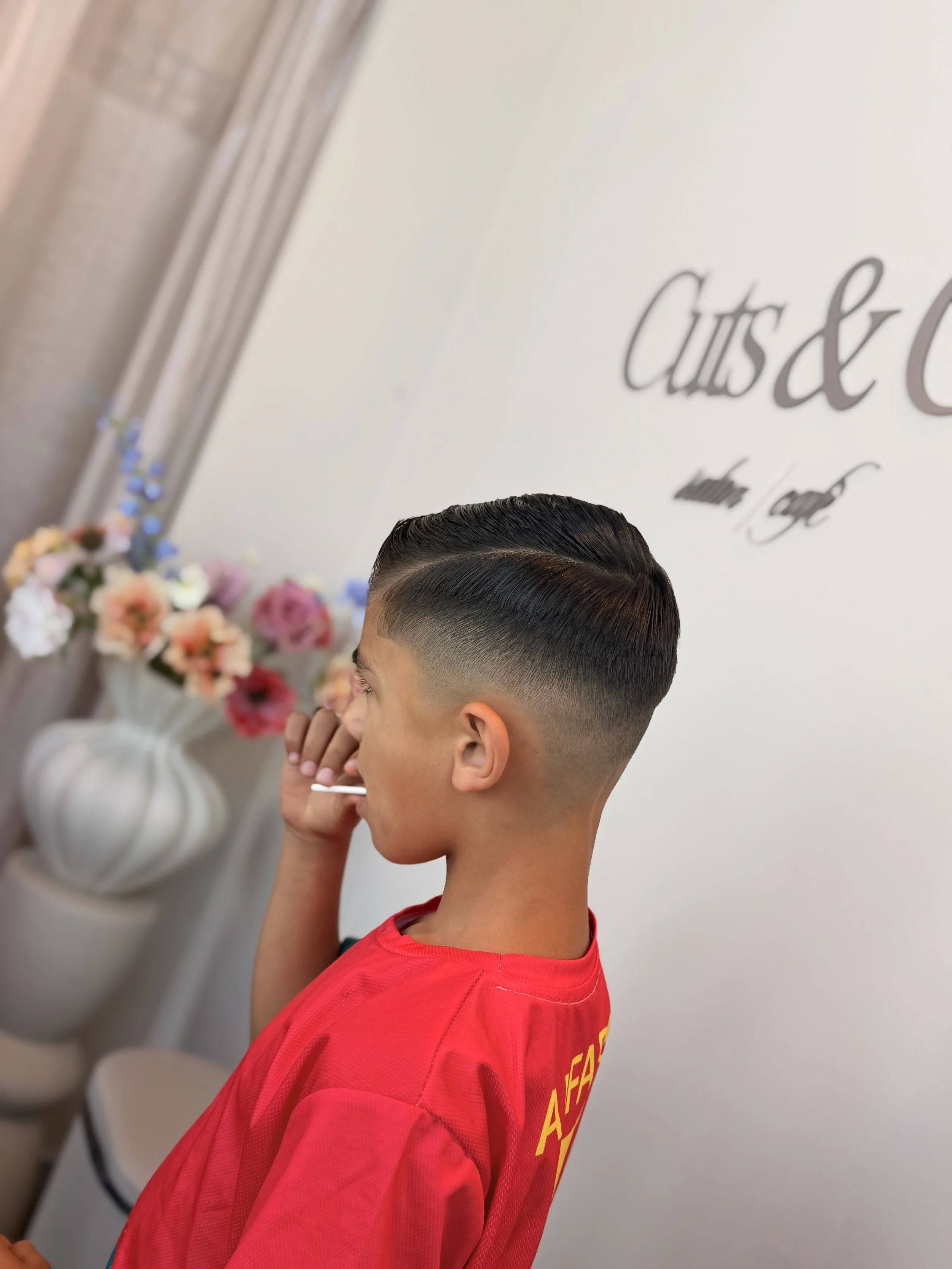 Logo for Cuts & Co., salon and café, established in 2016, on a gradient background.