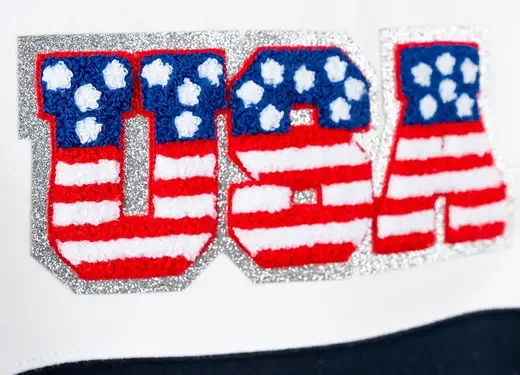 Decorative logo with the letters U, S, A designed with red and white stripes and blue sections with white stars, resembling the American flag.