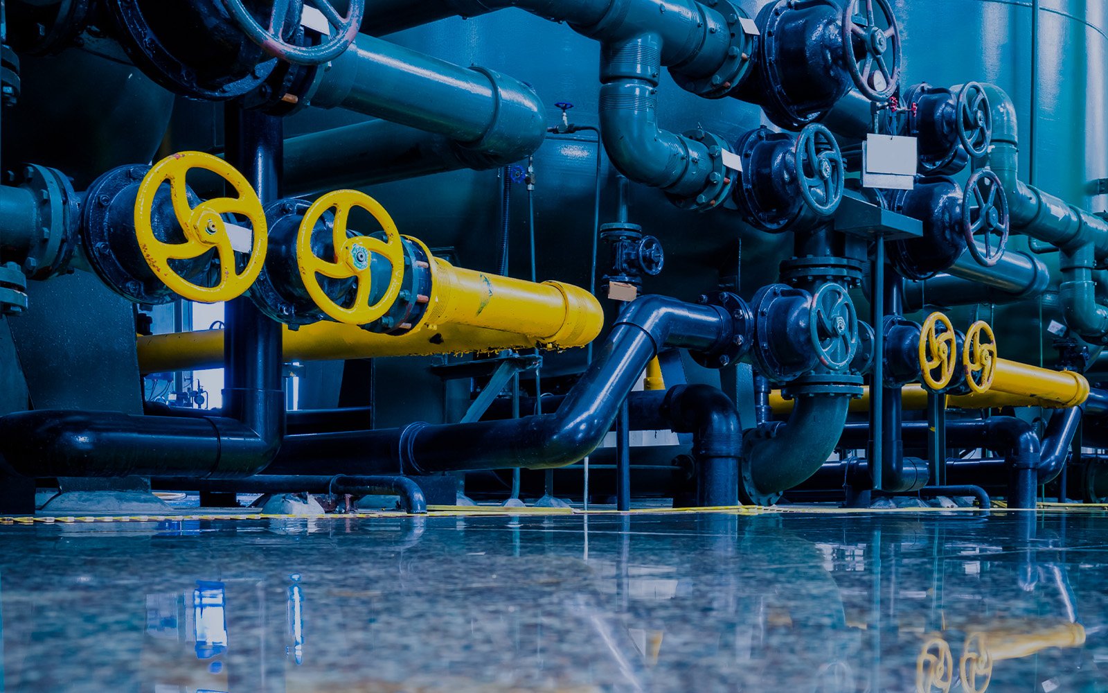 Industrial piping and control valves inside a process plant during maintenance operations