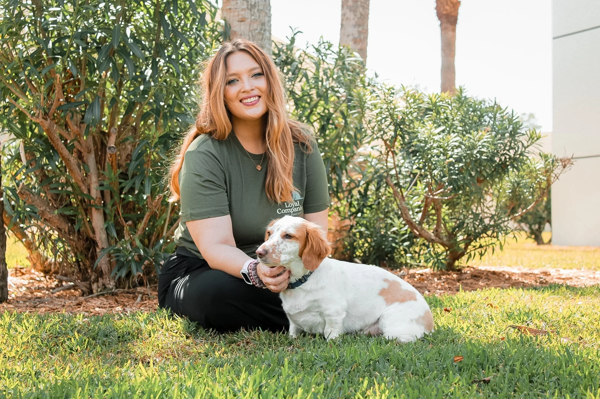 Autumn petsitter founder with dachshund dog outside sitting in grass