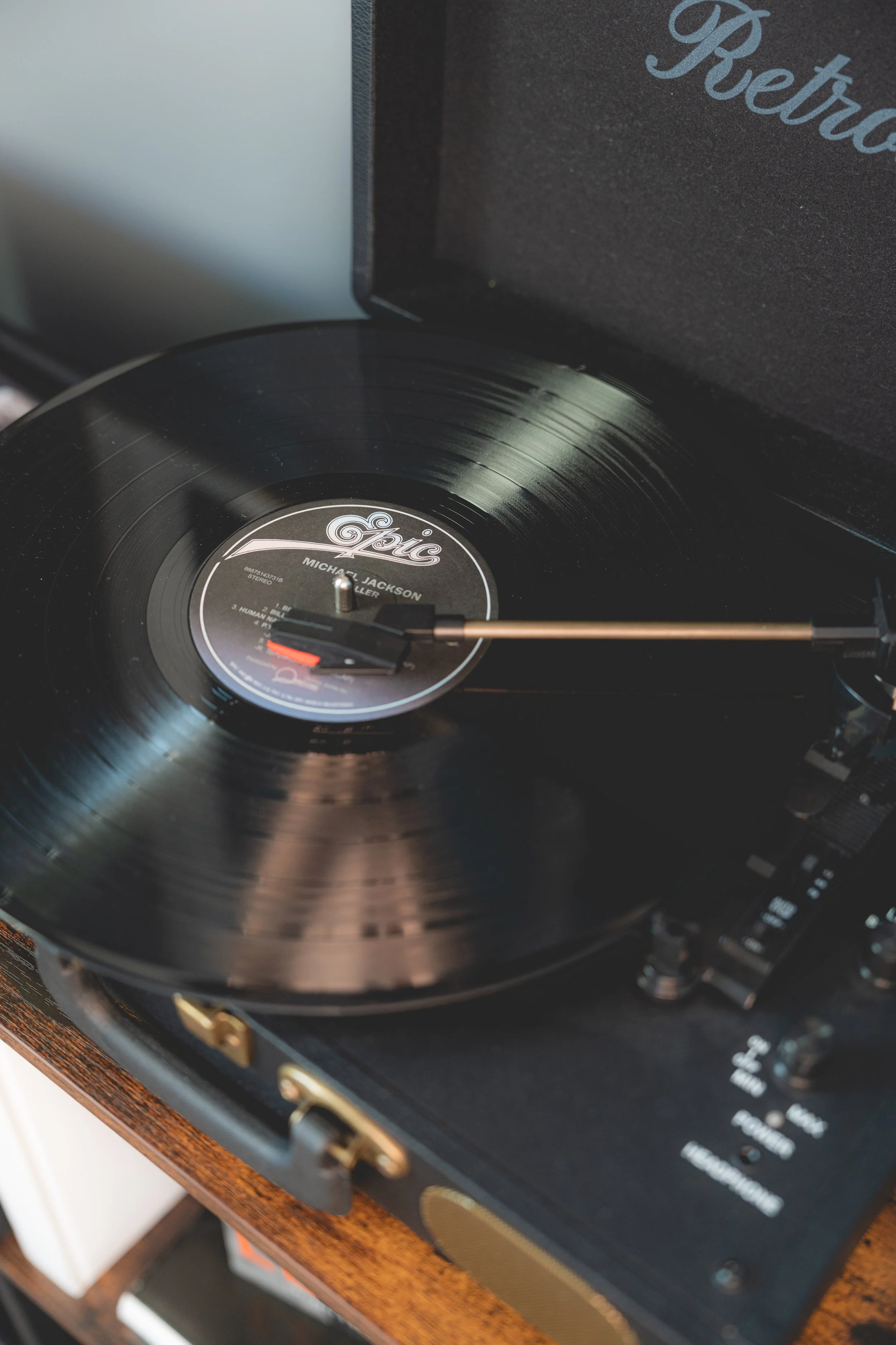 A vinyl record player playing Michael Jackson's "Thriller" album with the tone arm engaged on the record.