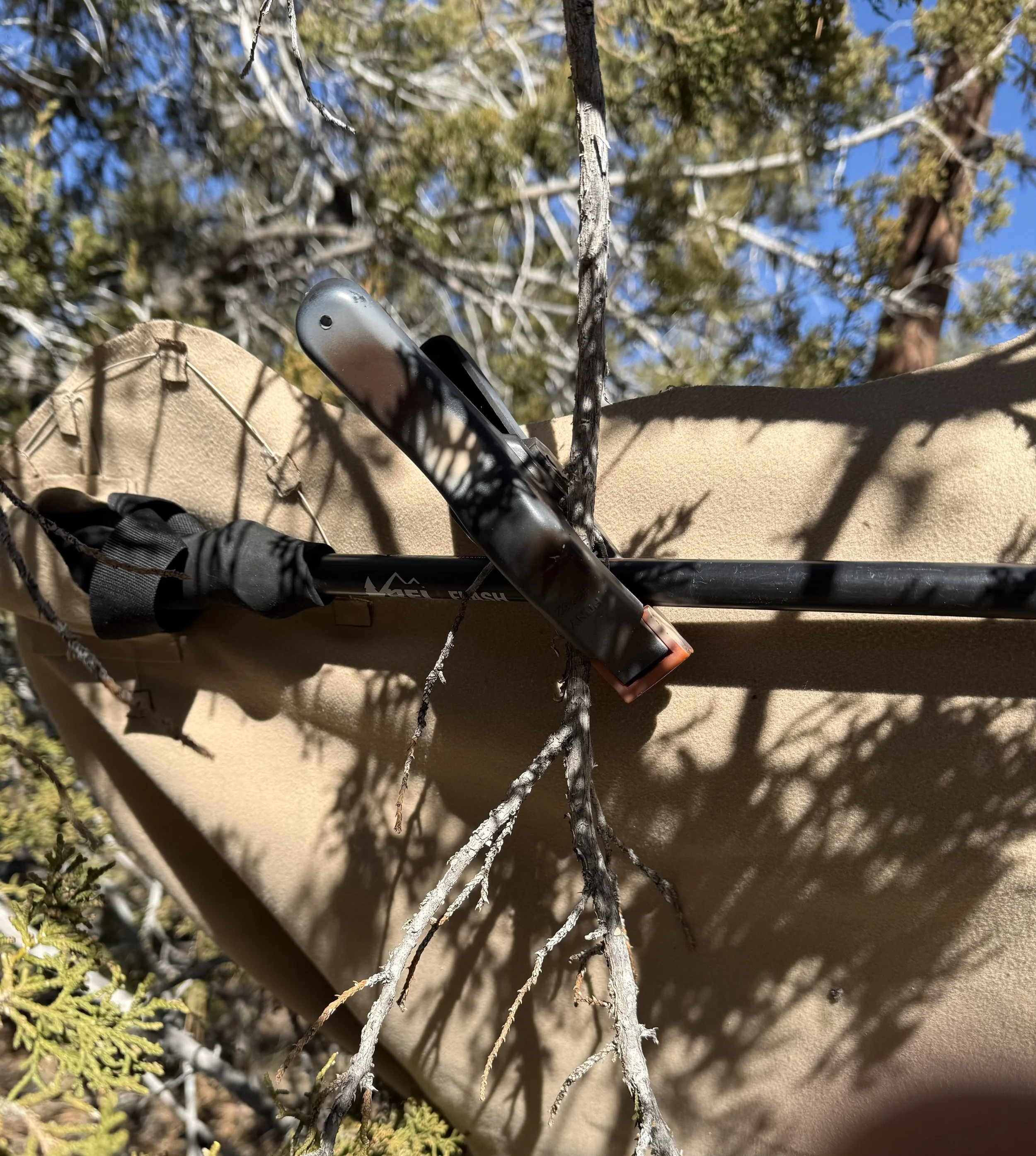 Attach trekking pole or stick to branch using spring clamp.