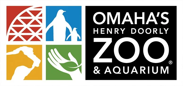 Omaha's Henry Doorly Zoo and Aquarium logo with colorful icons representing a roller coaster, penguin, animal head, and hand with a leaf.