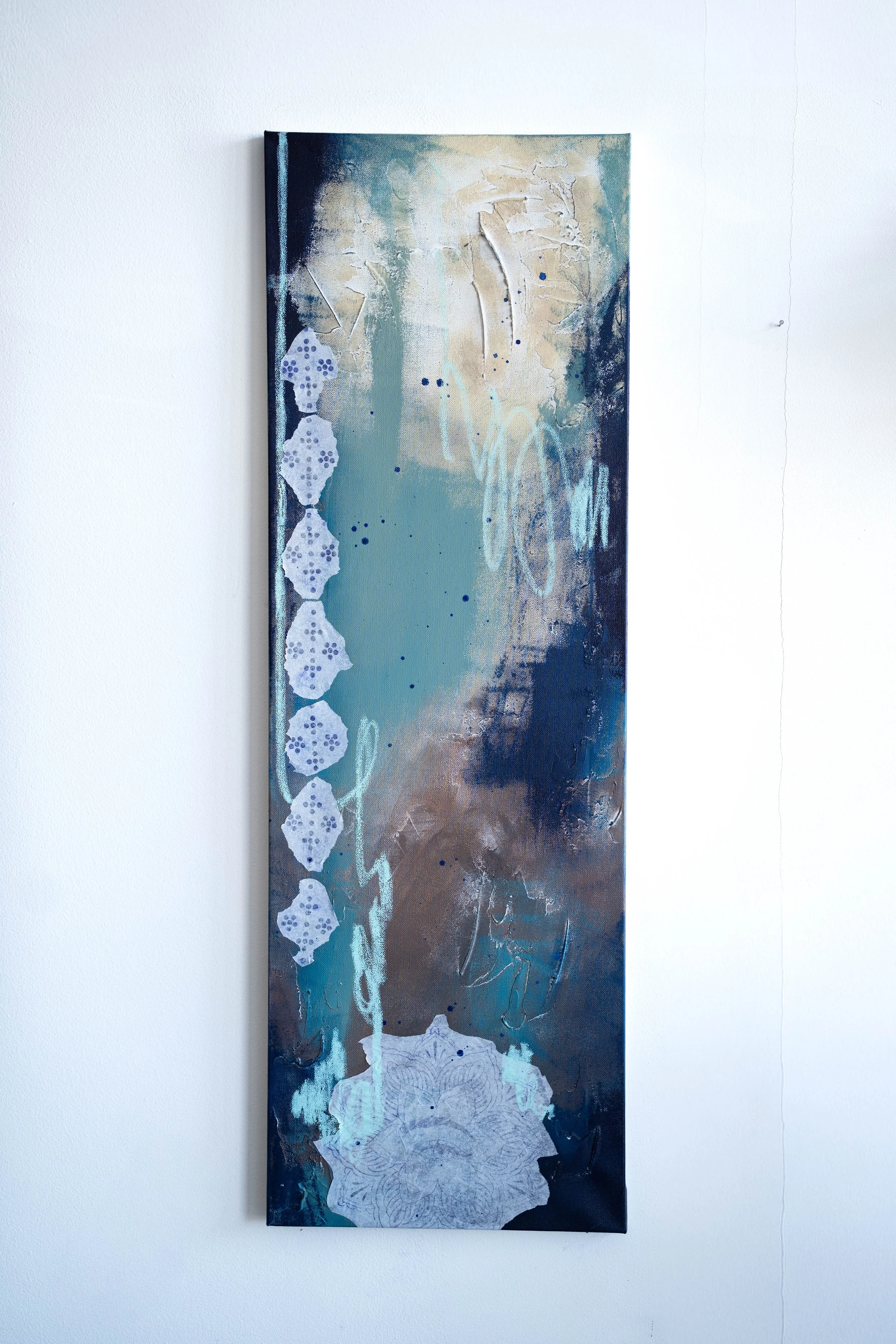 Abstract vertical painting with blue, beige, brown, and white colors, featuring geometric shapes and textured patterns.