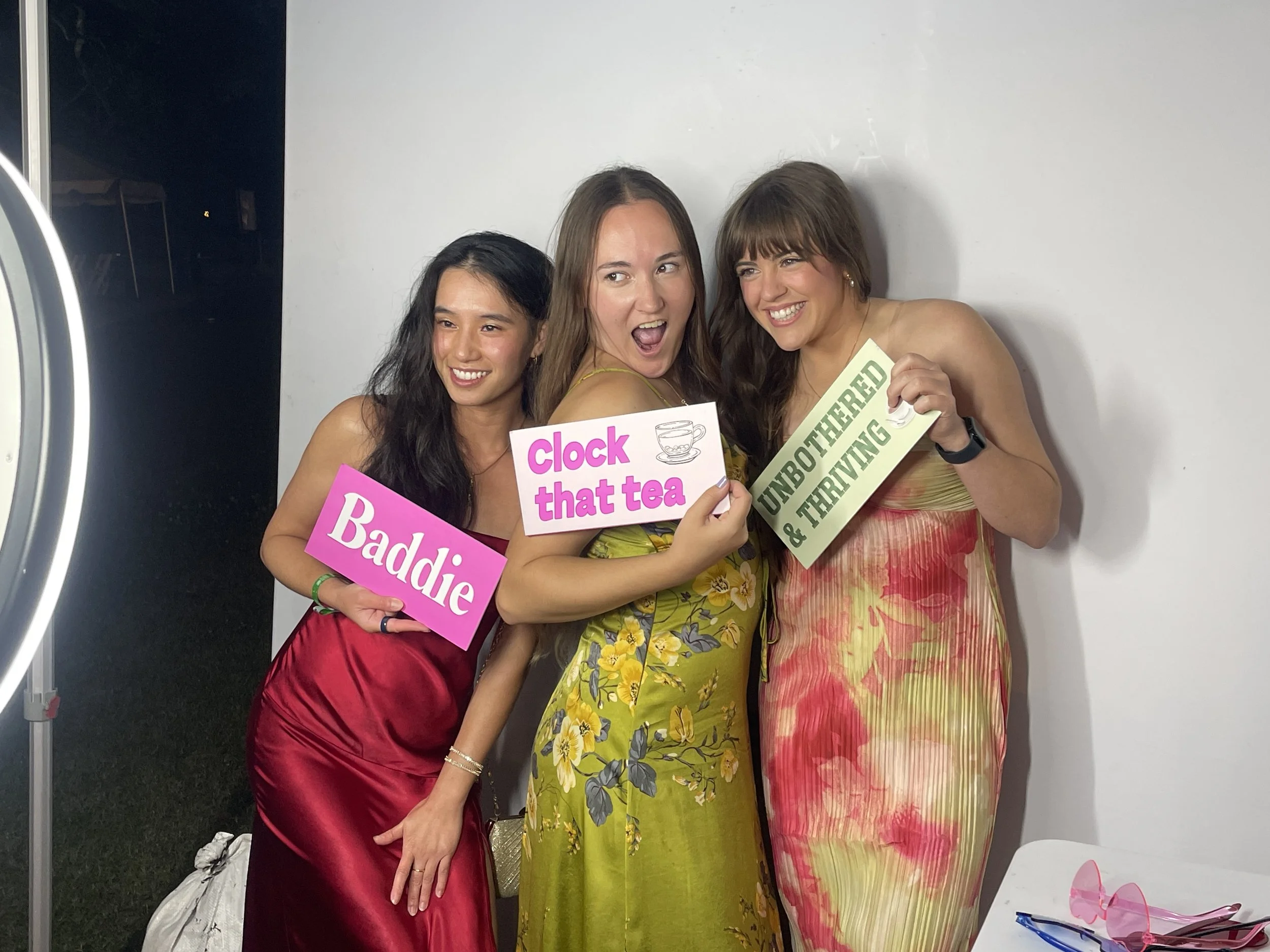 Corporate guests posing with fun signs at a luxury digital photo booth rental in New Orleans