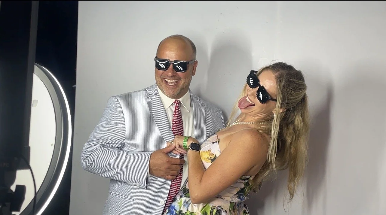 Couple posing at a corporate photo booth rental in New Orleans with custom digital photos and instant sharing.