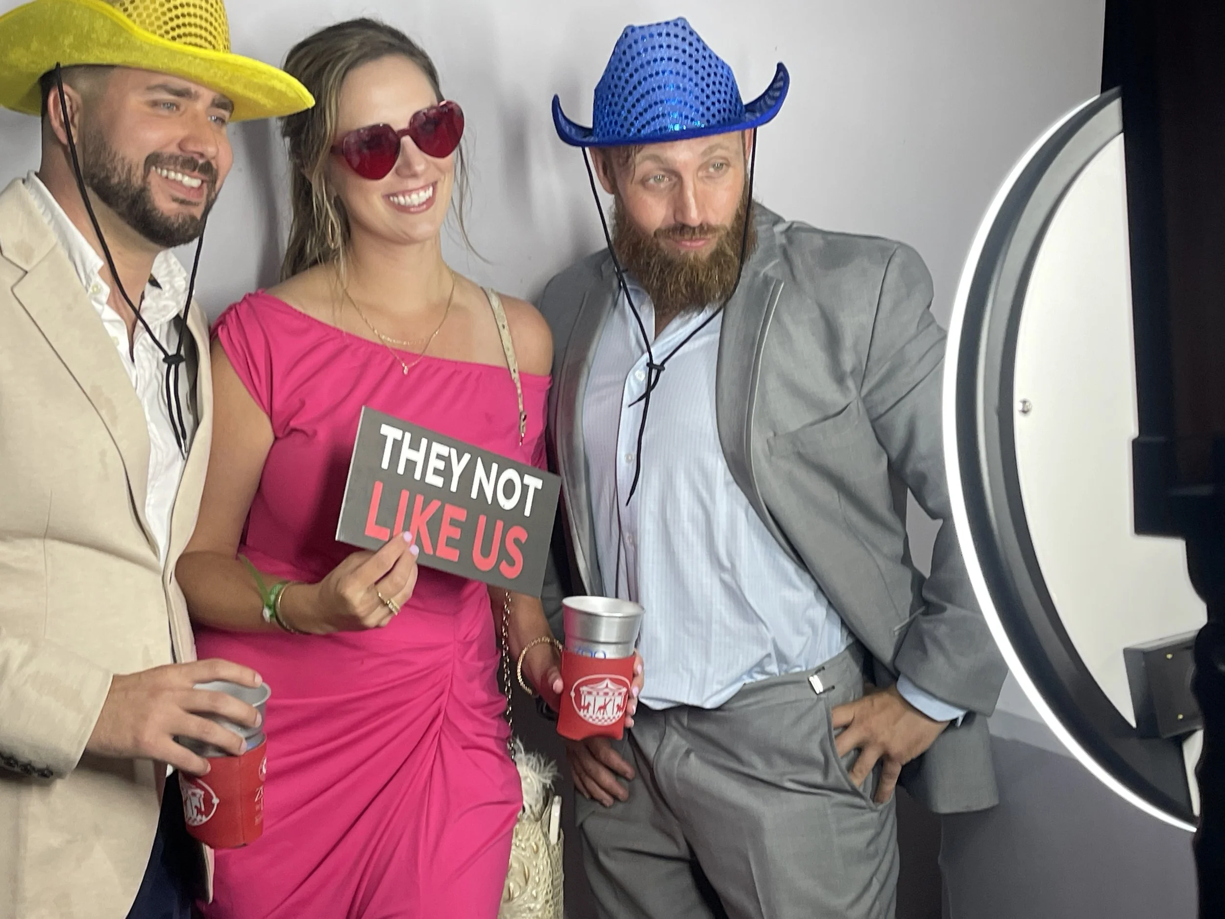 Guests posing with fun props at a luxury digital photo booth rental for a private event in New Orleans