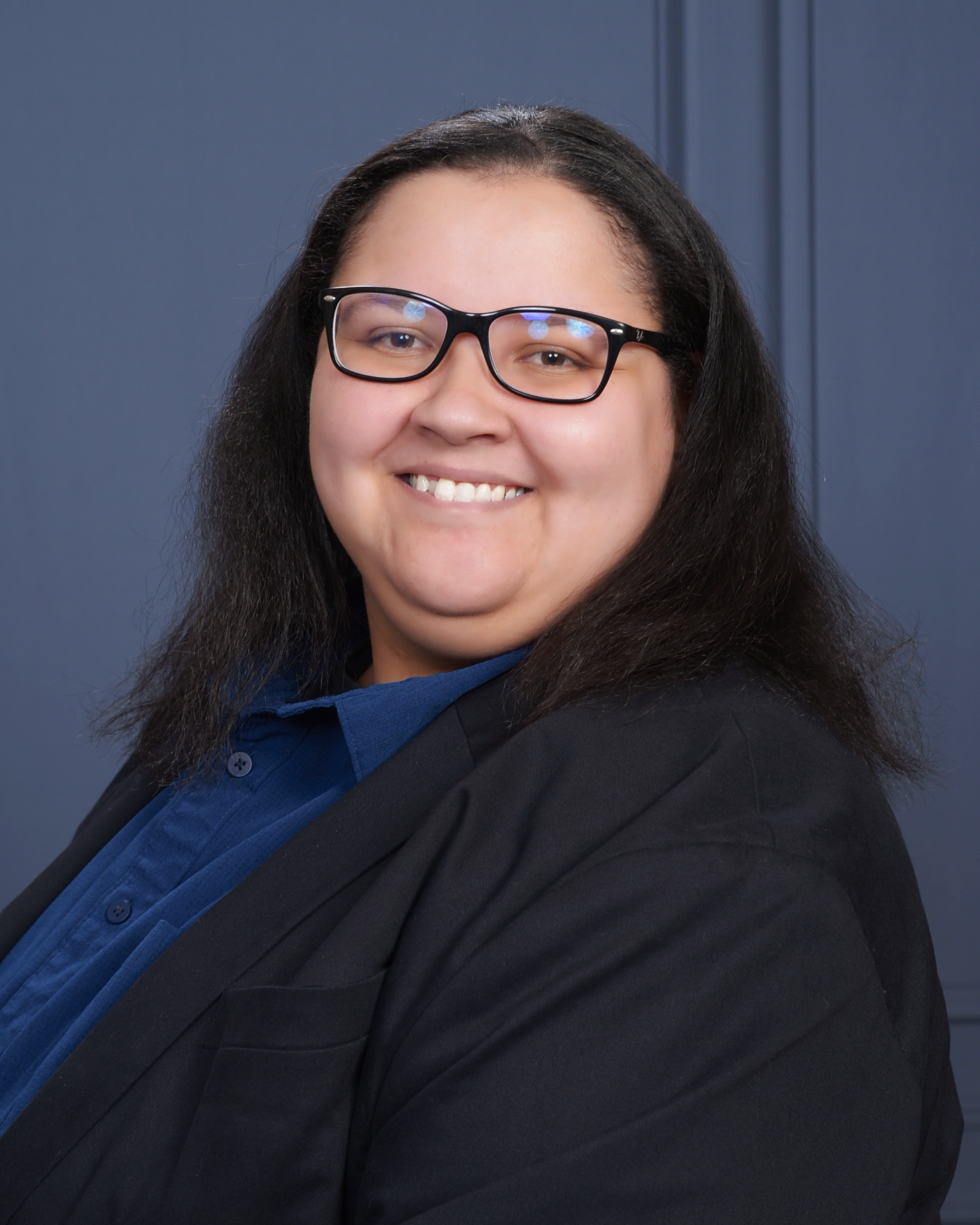 Holly E. Burgess, PhD Candidate, smiling in a professional headshot against a textured navy blue background