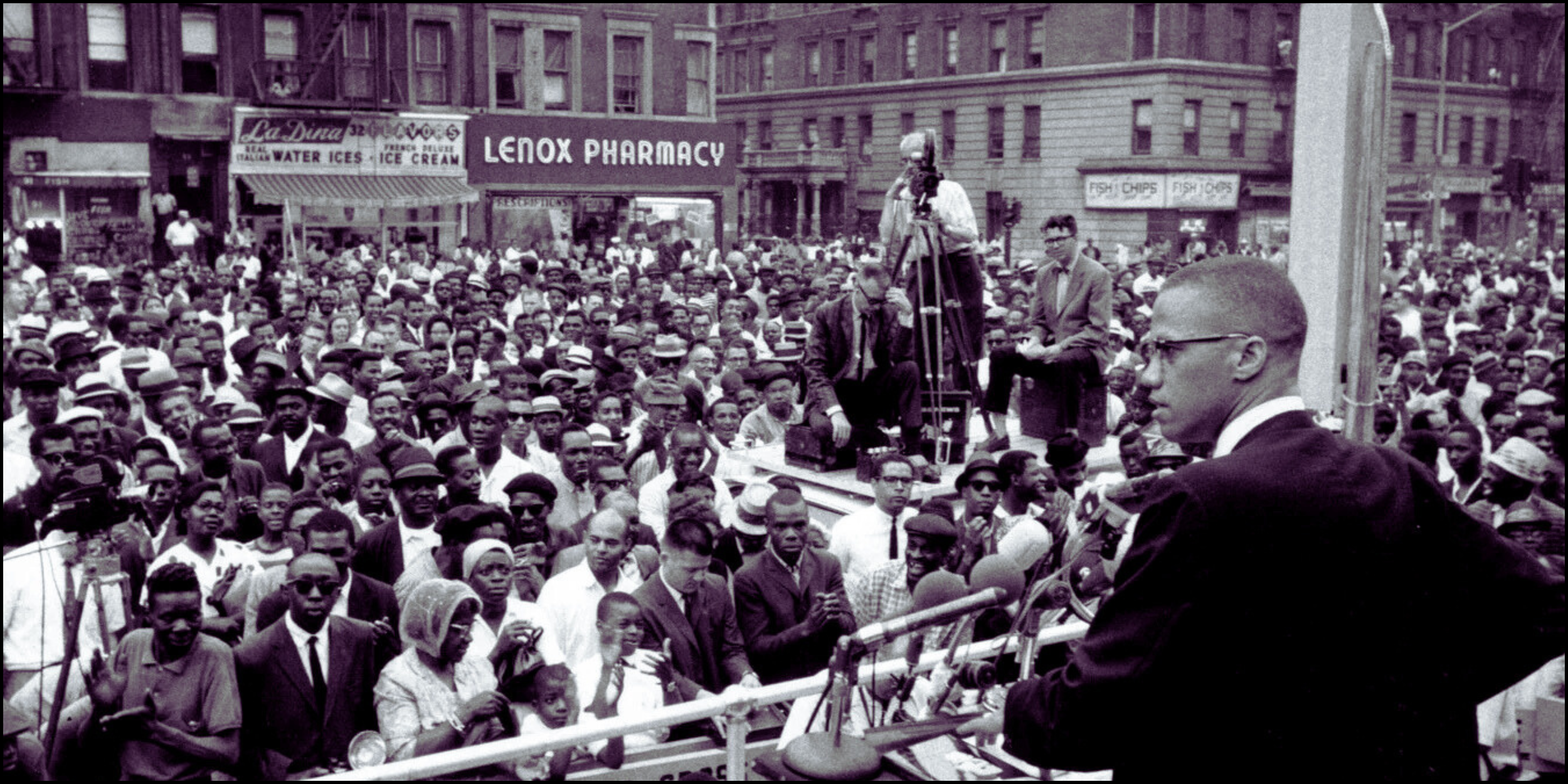 Malcolm X addressing a large public gathering in Harlem, capturing a moment of intense community engagement and oratorical power.