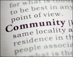 Close-up of the word "Community" in a dictionary, symbolizing a focus on collective identity and locality.