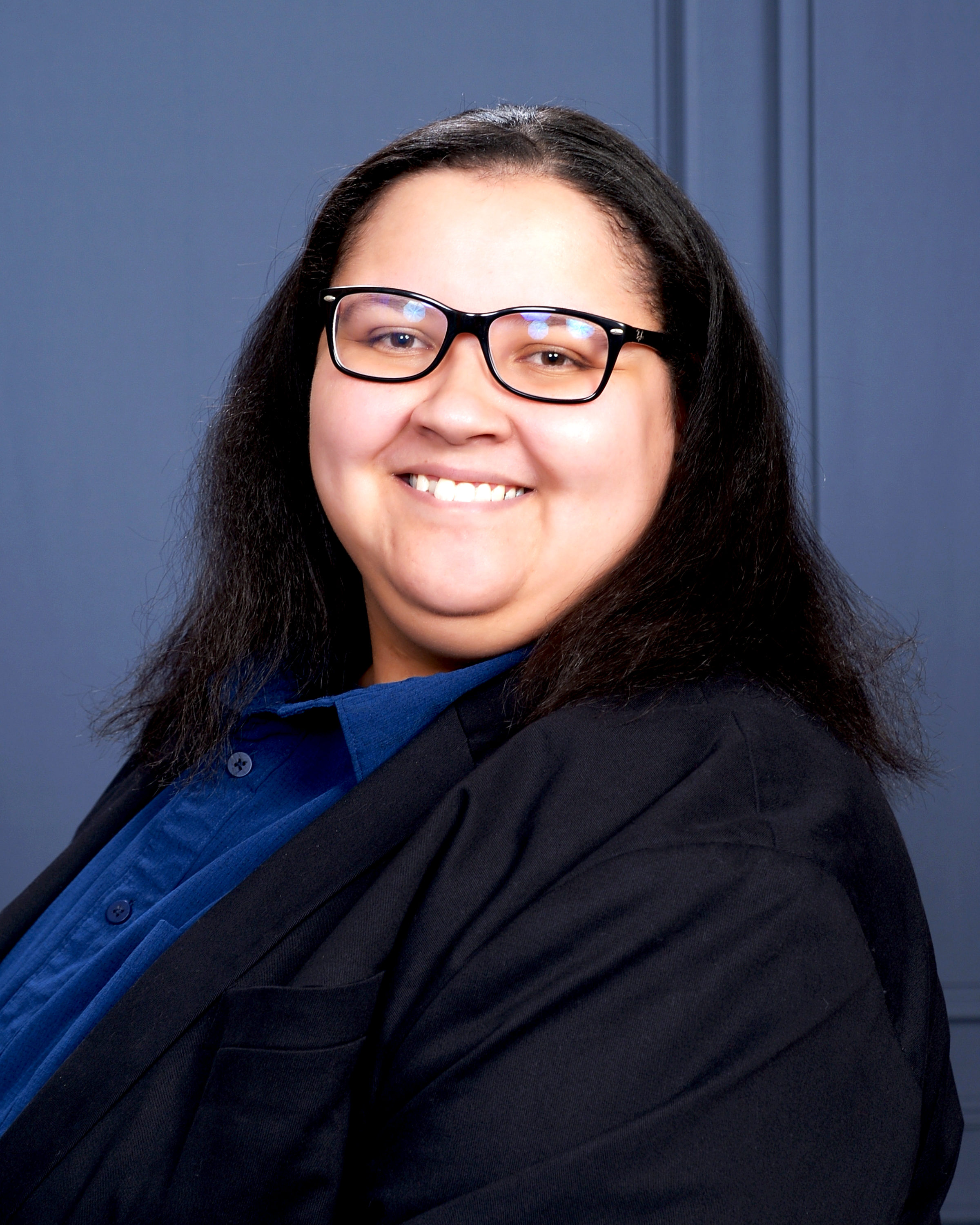 Holly E. Burgess, PhD Candidate, smiling in a professional headshot against a textured navy blue background