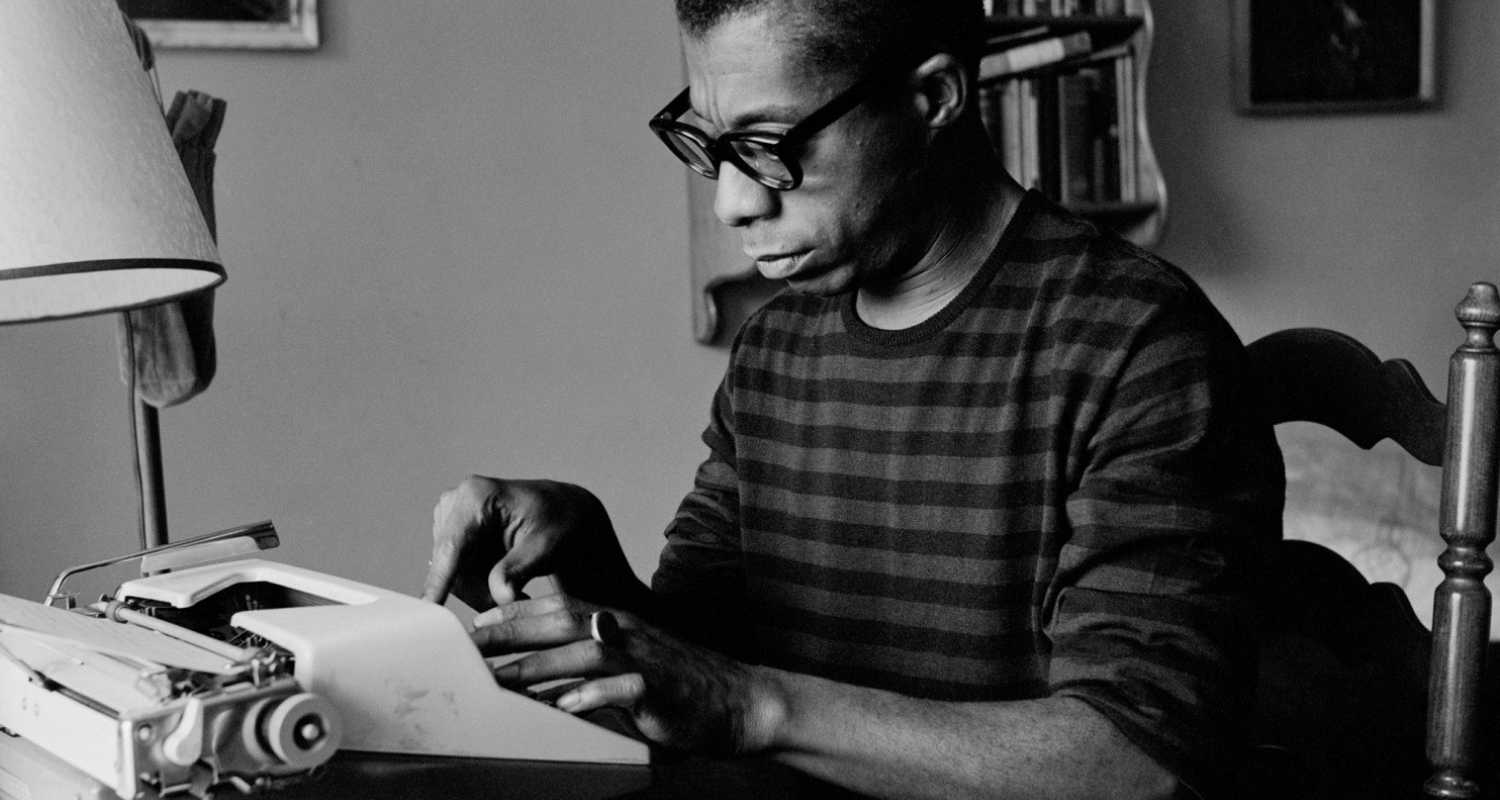 James Baldwin at his typewriter, a portrait of the author in his creative and scholarly element.
