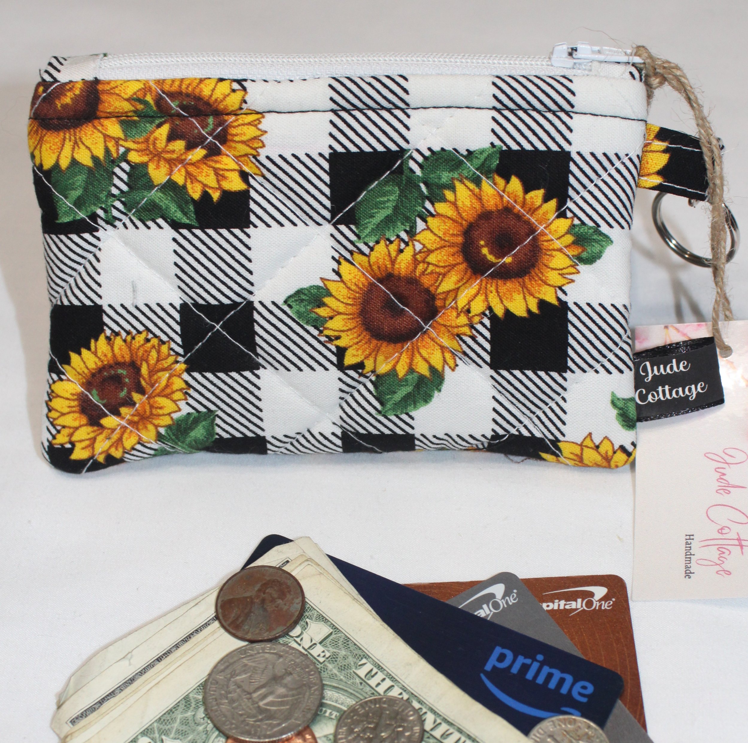 Quilted keychain wallet with sunflower and checkered pattern, zipper closure, and metal key ring.