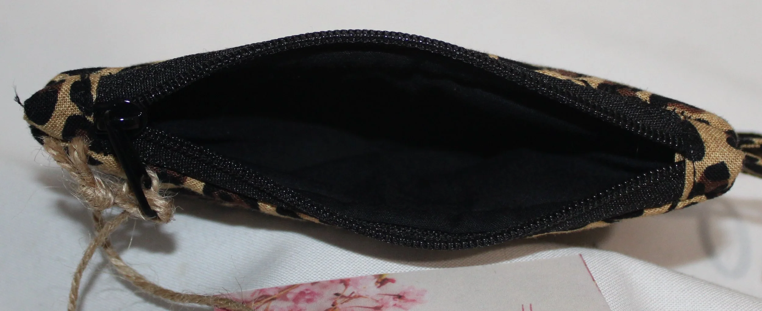 Top view of the Sahara, cheetah print keychain wallet with zipper closure and metal keyring.