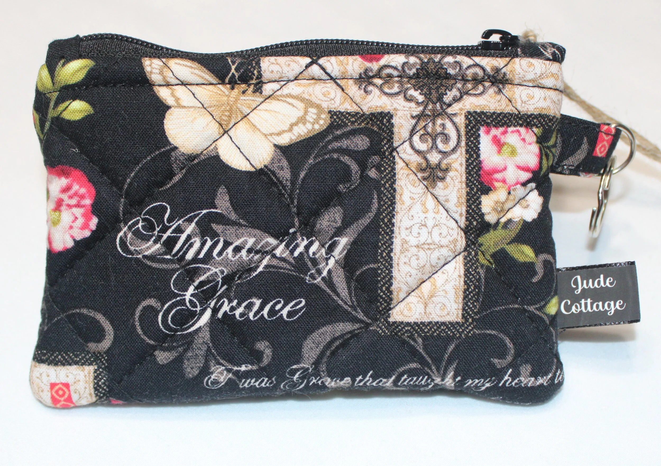 Quilted keychain wallet with Amazing Grace inspirational pattern, zipper closure, and metal key ring.