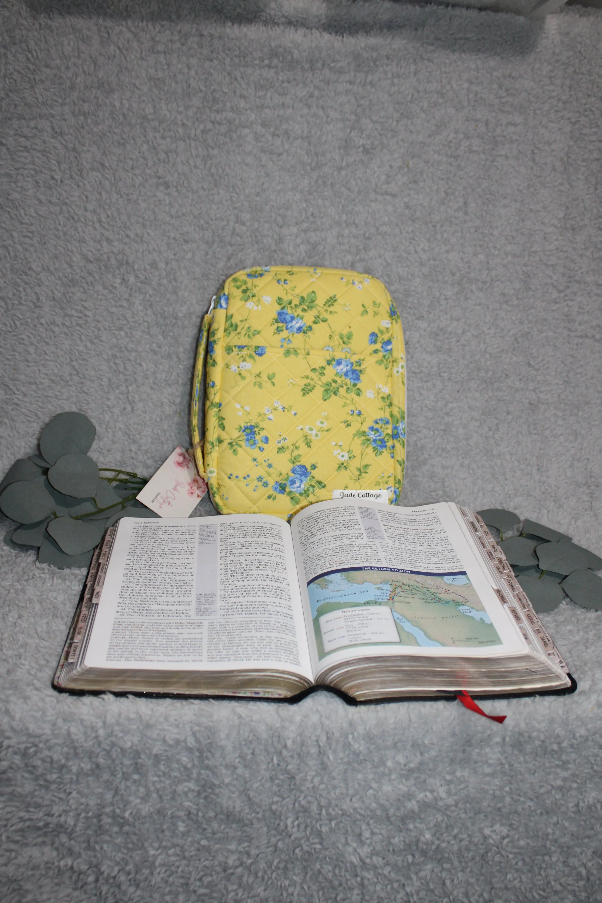 Front view of the Flora Study Bible Case, shown upright behind a Bible with the handle and front slip pocket visible.