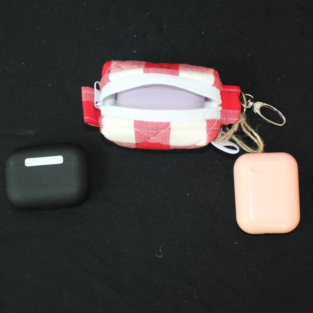 Open top view of the Stella Bag shown with a J Lab earbud case inserted for sizing demonstration.