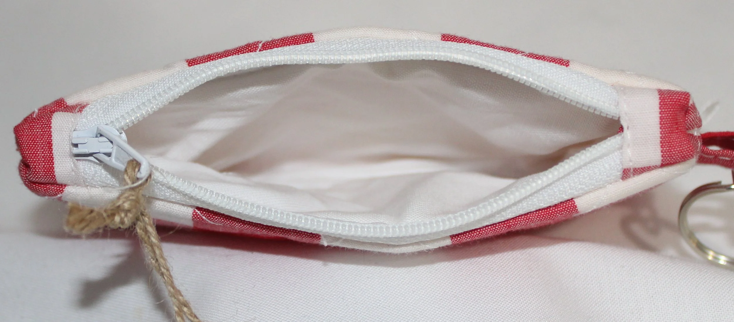 Top view quilted keychain wallet with bright modern pattern, zipper closure, and metal key ring.