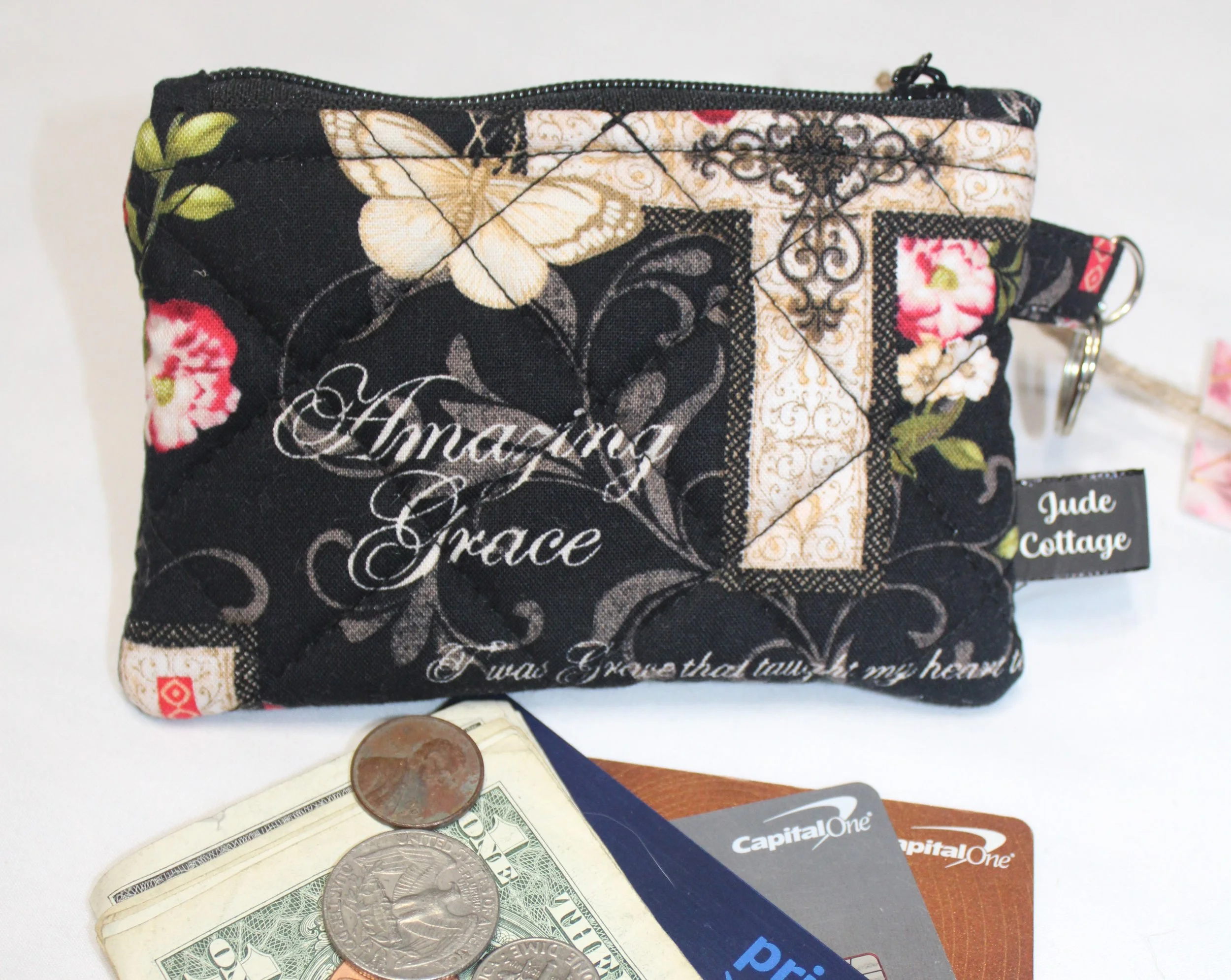 Quilted keychain wallet with Amazing Grace inspirational pattern, zipper closure, and metal key ring.