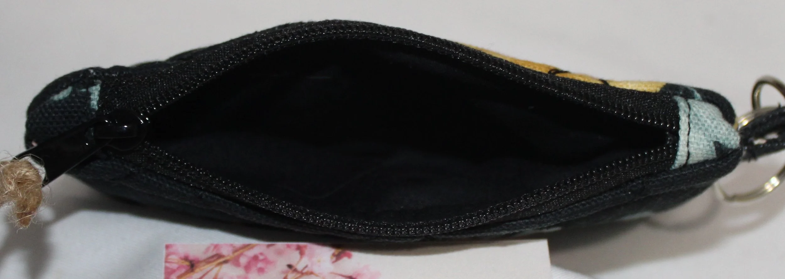 “Top view of the Twyla, quilted keychain wallet showing the black  lining.