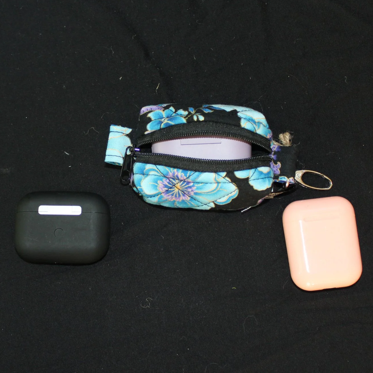 Top view of open zippered Twilight Paisley Bag Charm shown with J Lab earbud case inserted for sizing reference.