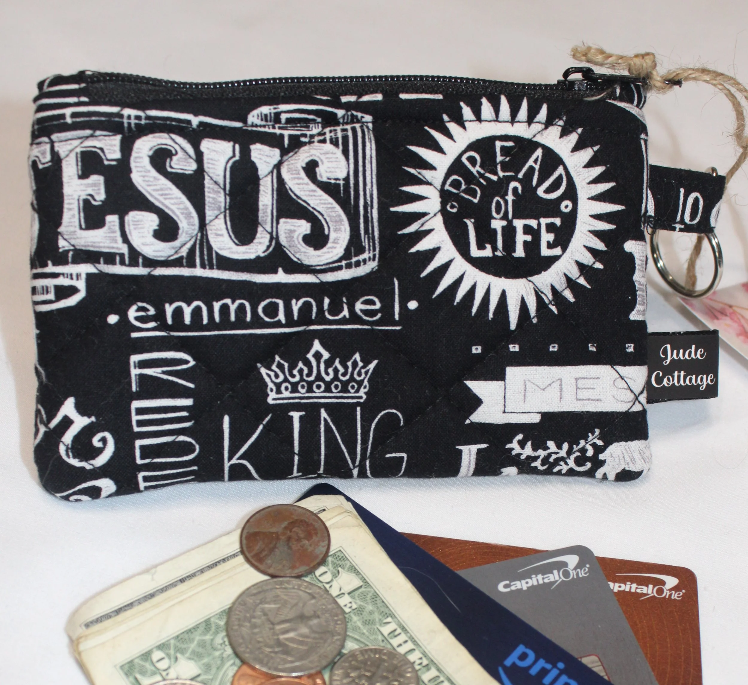 Quilted keychain wallet with King of Kings design, zipper closure, and metal key ring.