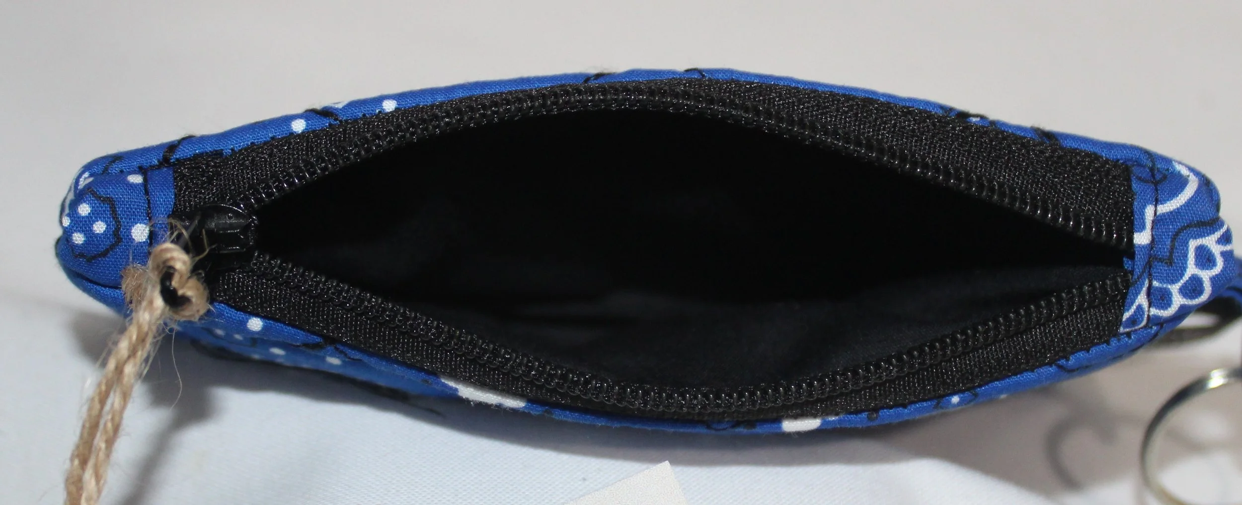 Top view of blue bandana-pattern quilted keychain wallet with zipper closure and metal key ring.