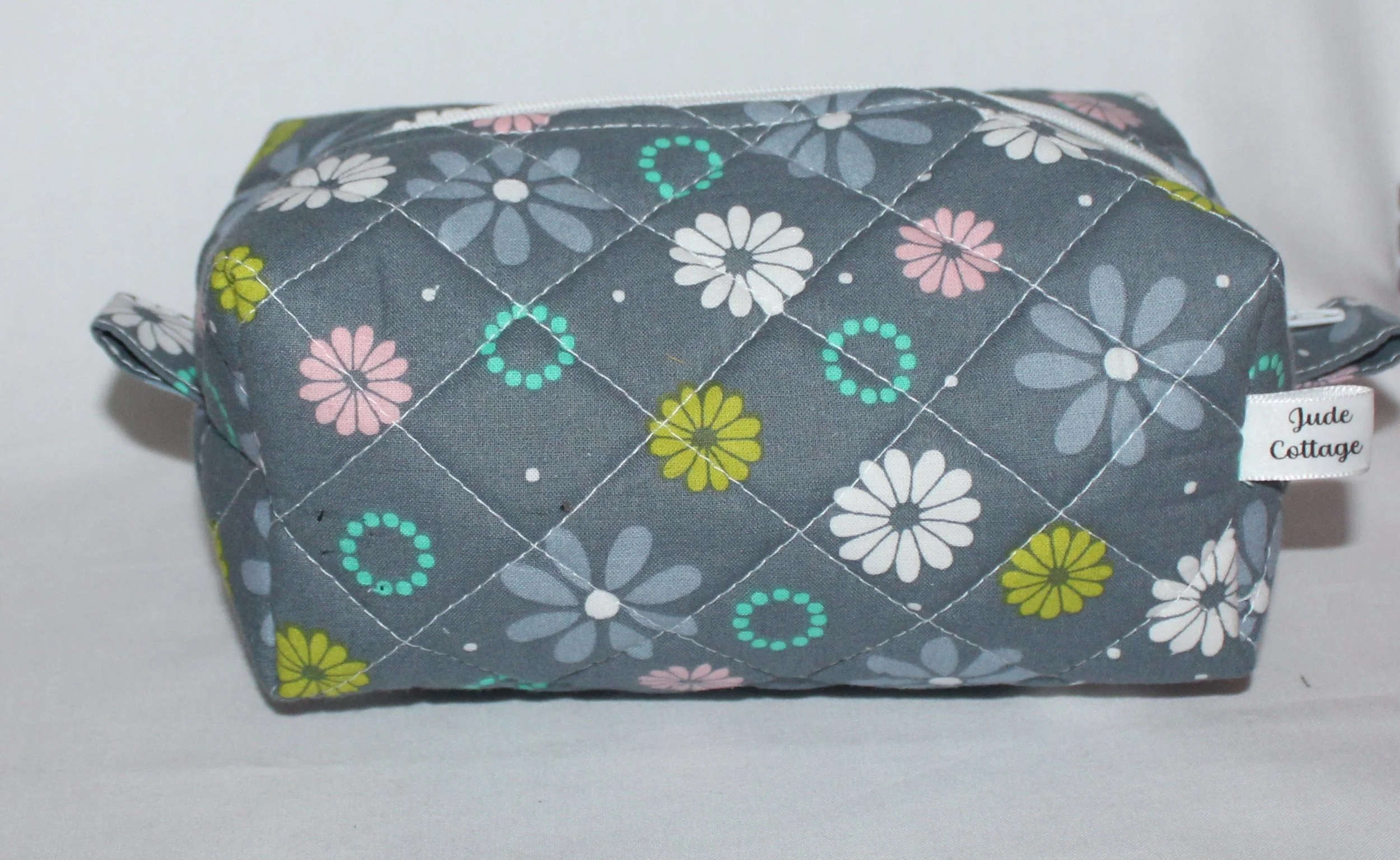 Front closed view of the Phoebe quilted travel pouch in floral print.