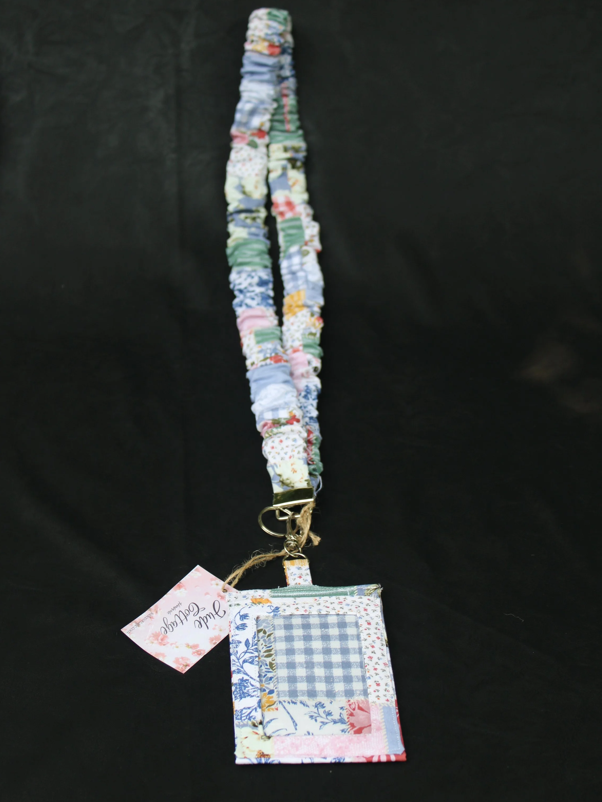 Front view of the Serenity Scrunch lanyard and badge holder featuring a floral patchwork print in multiple colors.