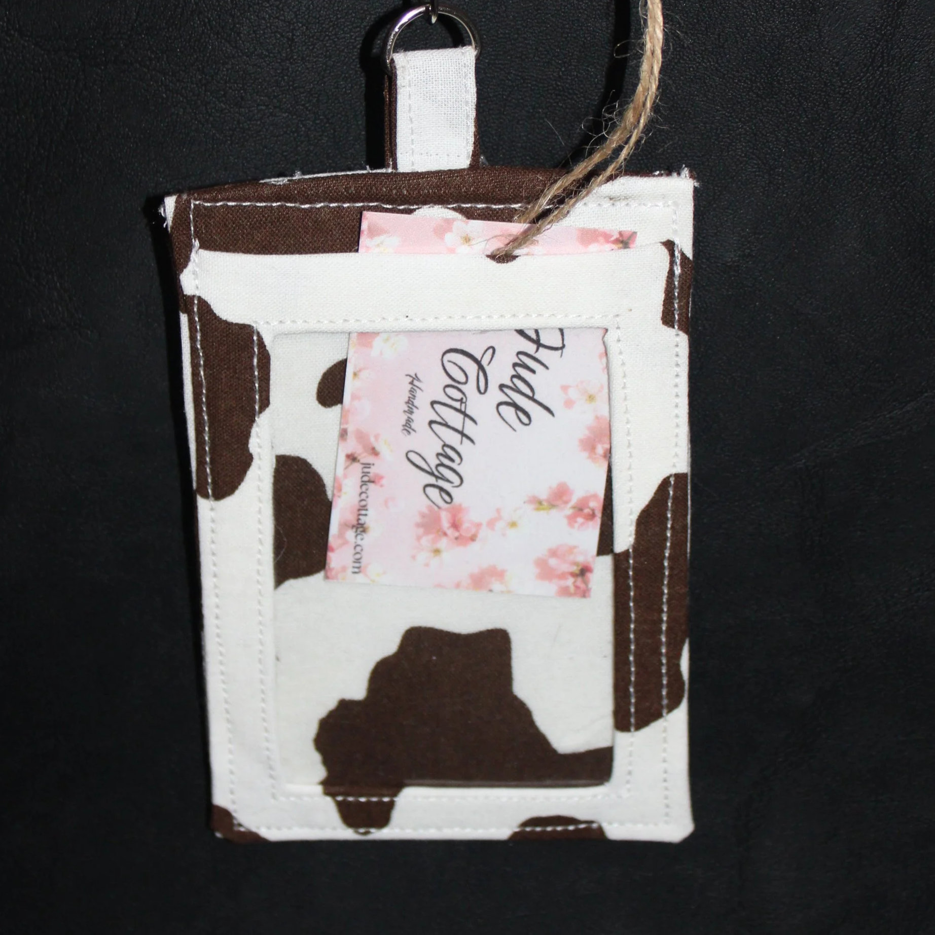 Front view of the Brown Cow Badge Holder shown with card inserted to illustrate clear ID slot.