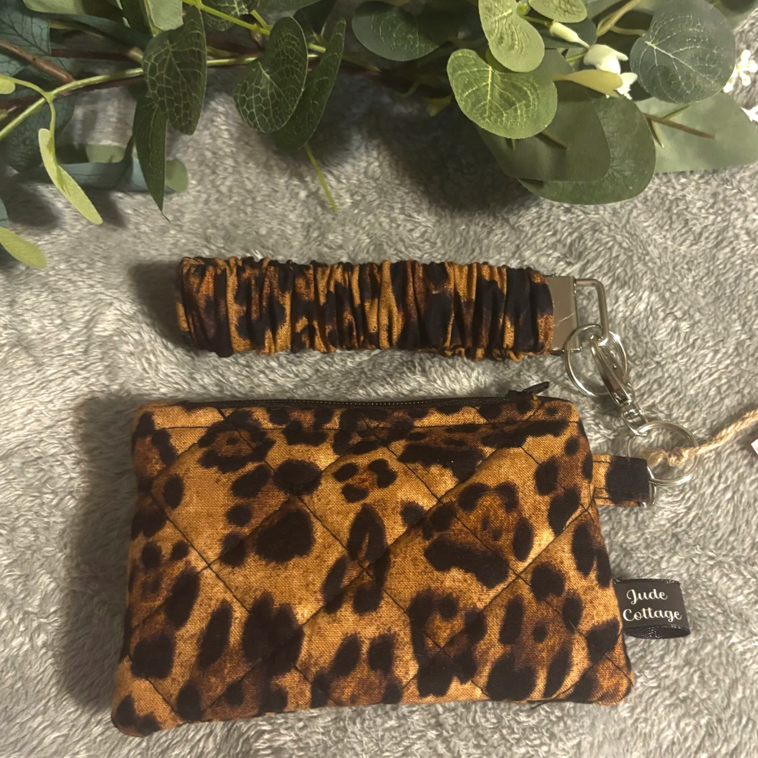 Front flat view of the Lyra Keychain Wallet Set shown with matching Scrunch wristlet featuring a bold leopard print fabric.